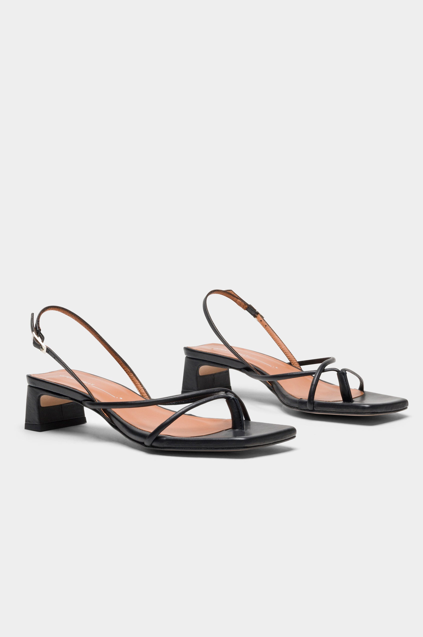 Fifi strappy slingback shoe with a block heel and adjustable heel strap in Black colorway - side view of shoe pair