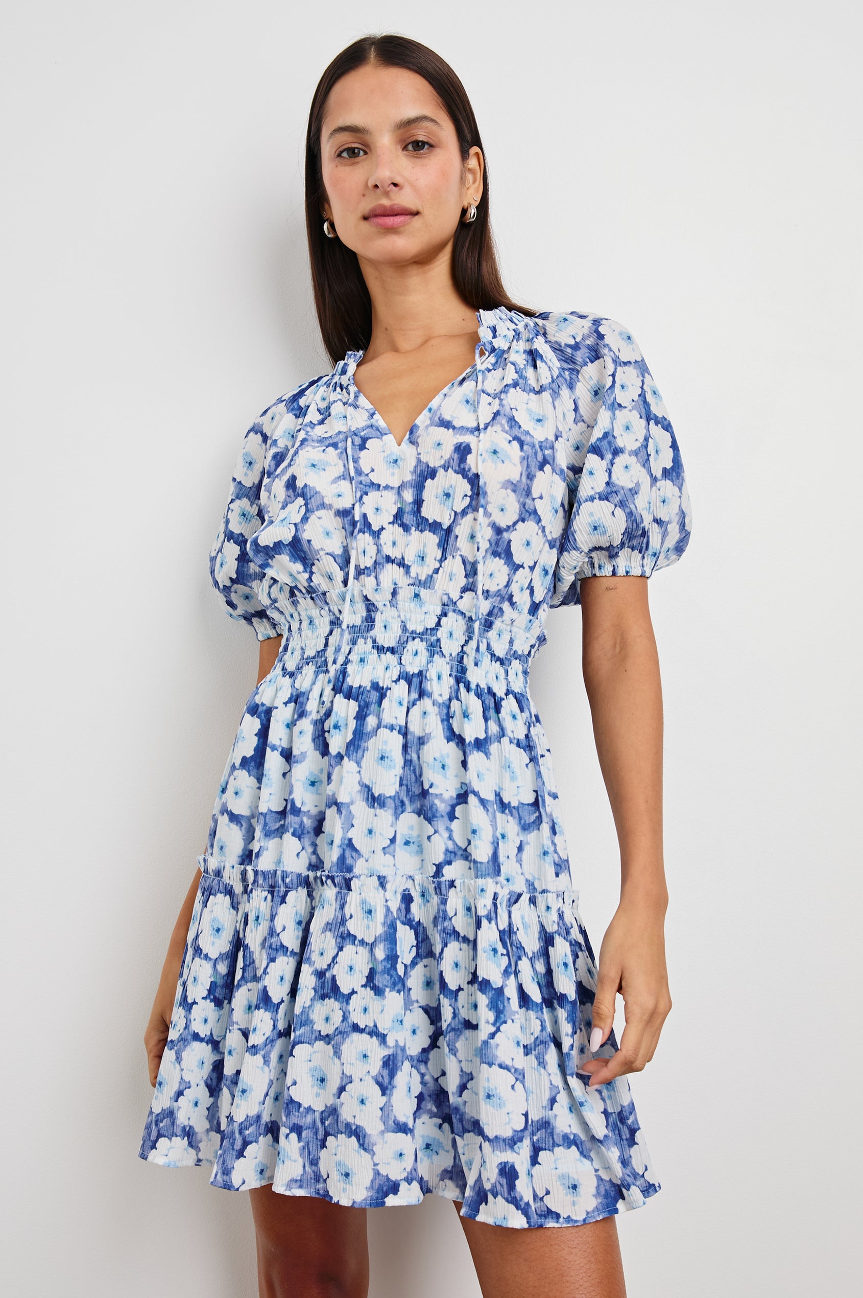 Fiorella Short-Sleeve, Above-Knee Dress with a Shirred Collar and Waist, V-neckline with Ties, Puff Sleeves and a Tiered Skirt in Blue Floral Colorway, Blues and White - Front View Featured on Model