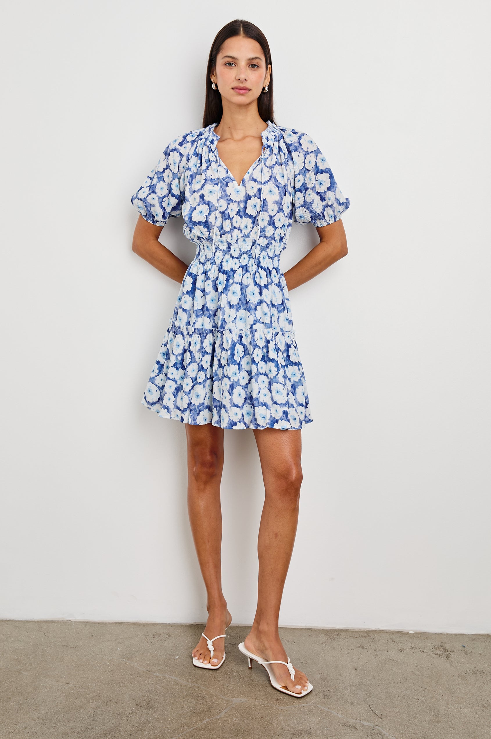 Fiorella Short-Sleeve, Above-Knee Dress with a Shirred Collar and Waist, V-neckline with Ties, Puff Sleeves and a Tiered Skirt in Blue Floral Colorway, Blues and White - Front Full Body View Featured on Model
