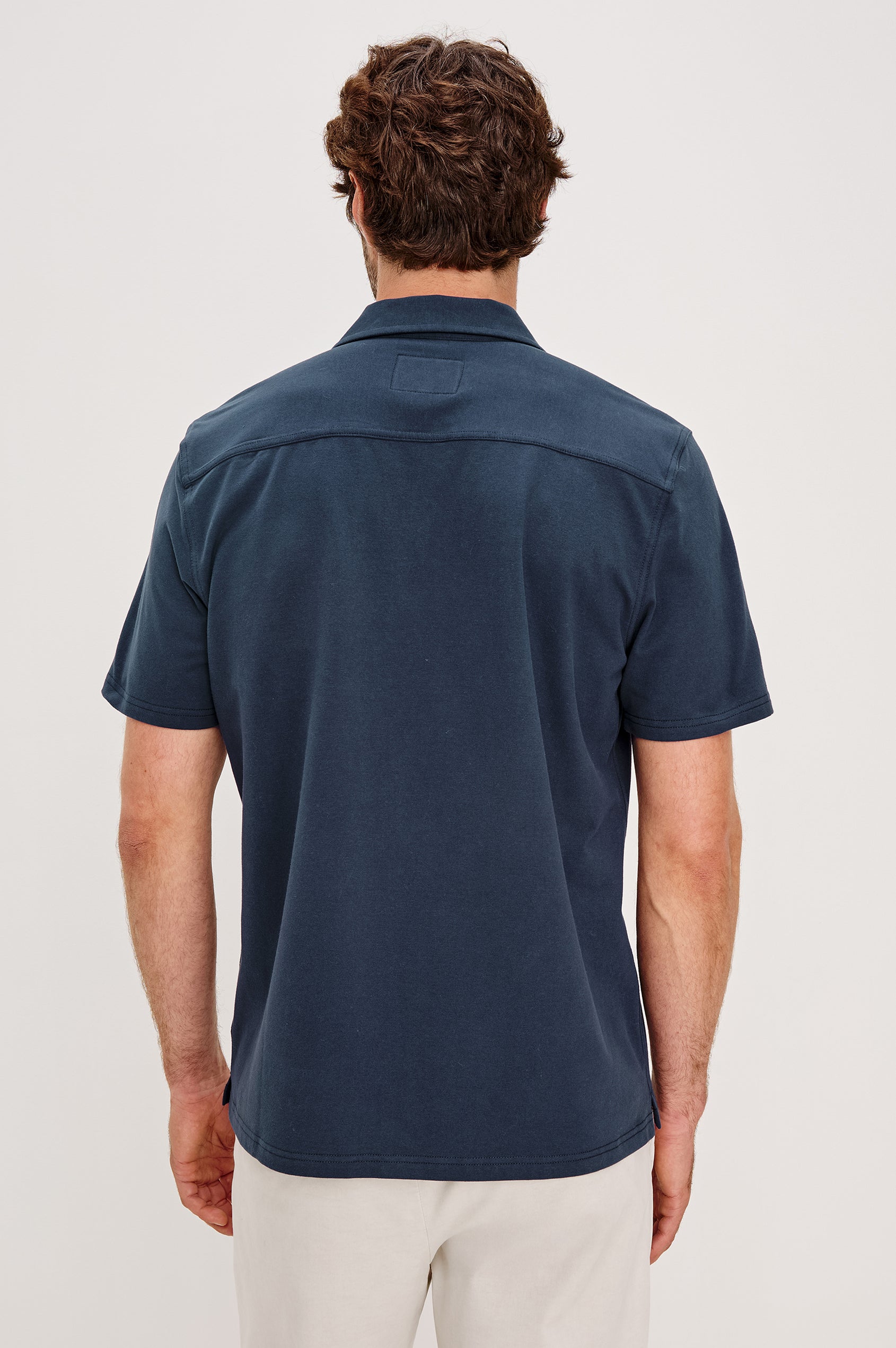 Flint Collared Button Shirt with Short Sleeves and a Chest Pocket in Perfect Navy Colorway. Back View Shown on Model.