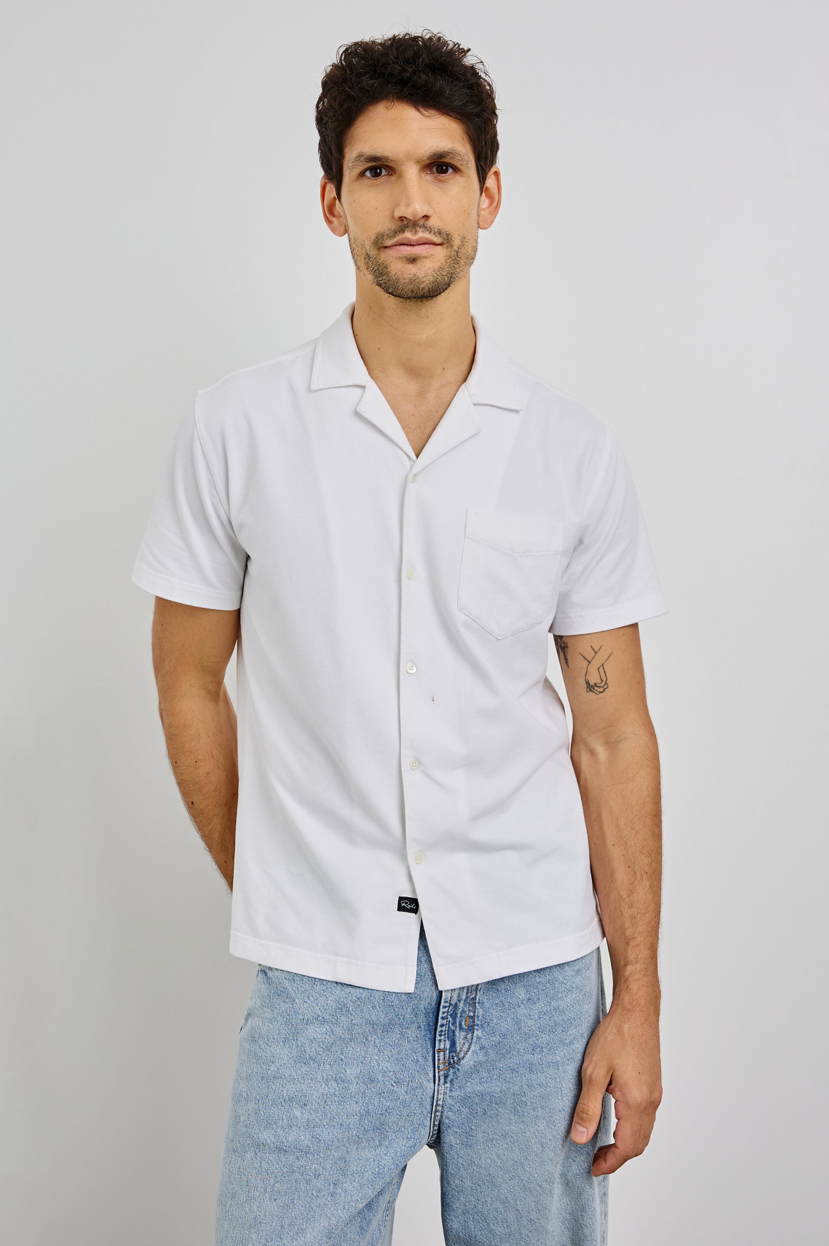 Flint Collared Button Shirt with Short Sleeves and a Chest Pocket in White Colorway. Front View Shown on Model.