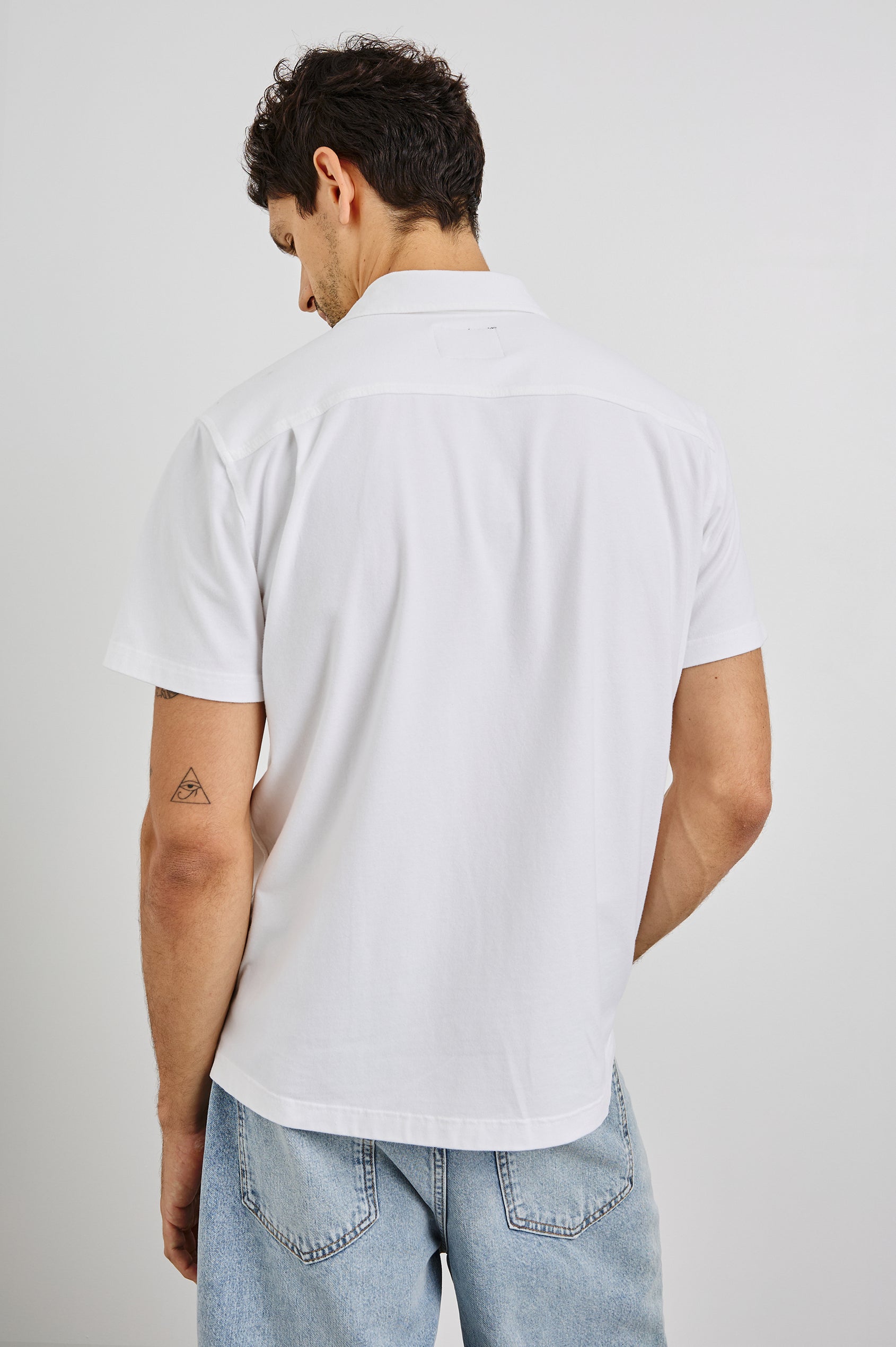 Flint Collared Button Shirt with Short Sleeves and a Chest Pocket in White Colorway. Back View Shown on Model.