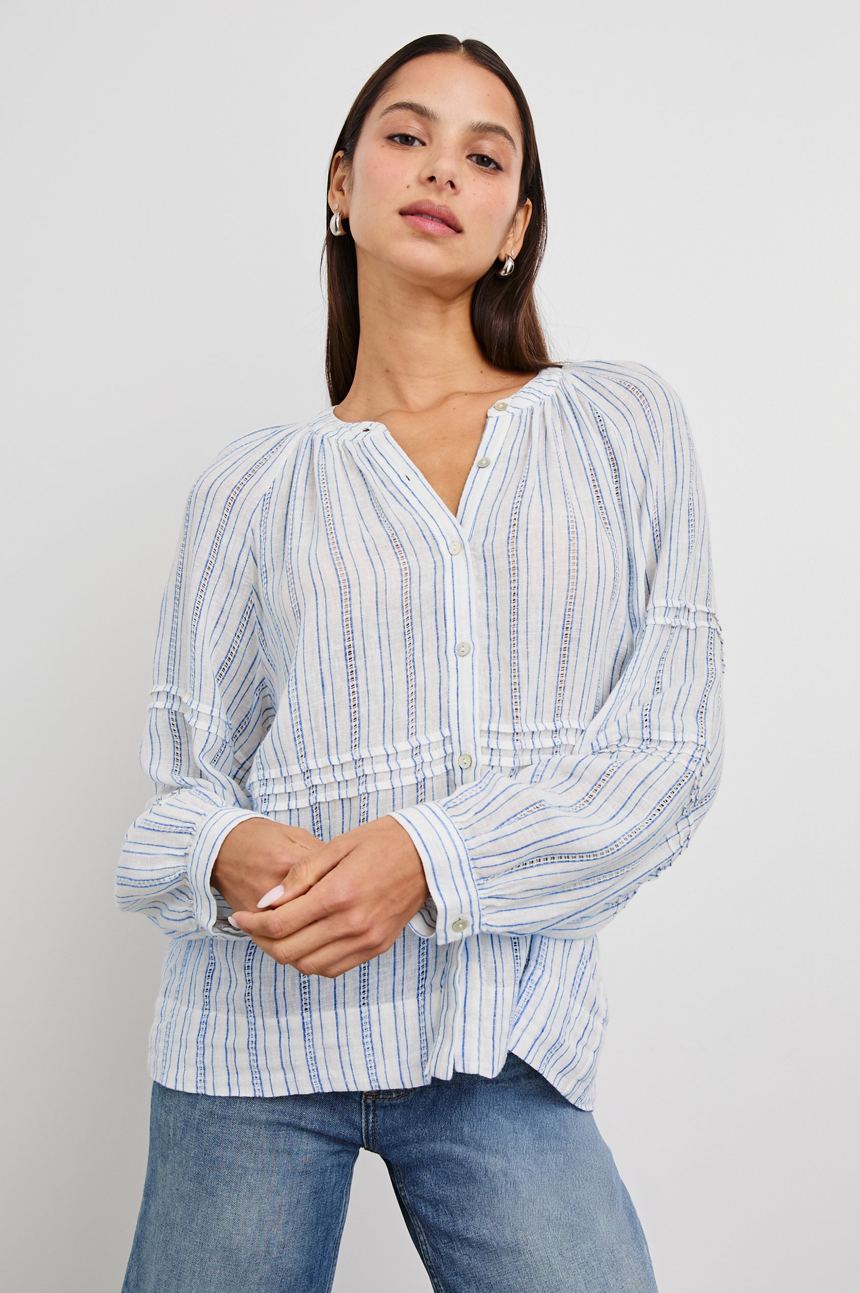 Frances Long-Sleeve Top with Buttons Down the Front, Button Cuffs, and Pleating Around the Neckline in Sonoma Stripe Colorway, Thin Blue Vertical Stripes on White - Front View Featured on Model