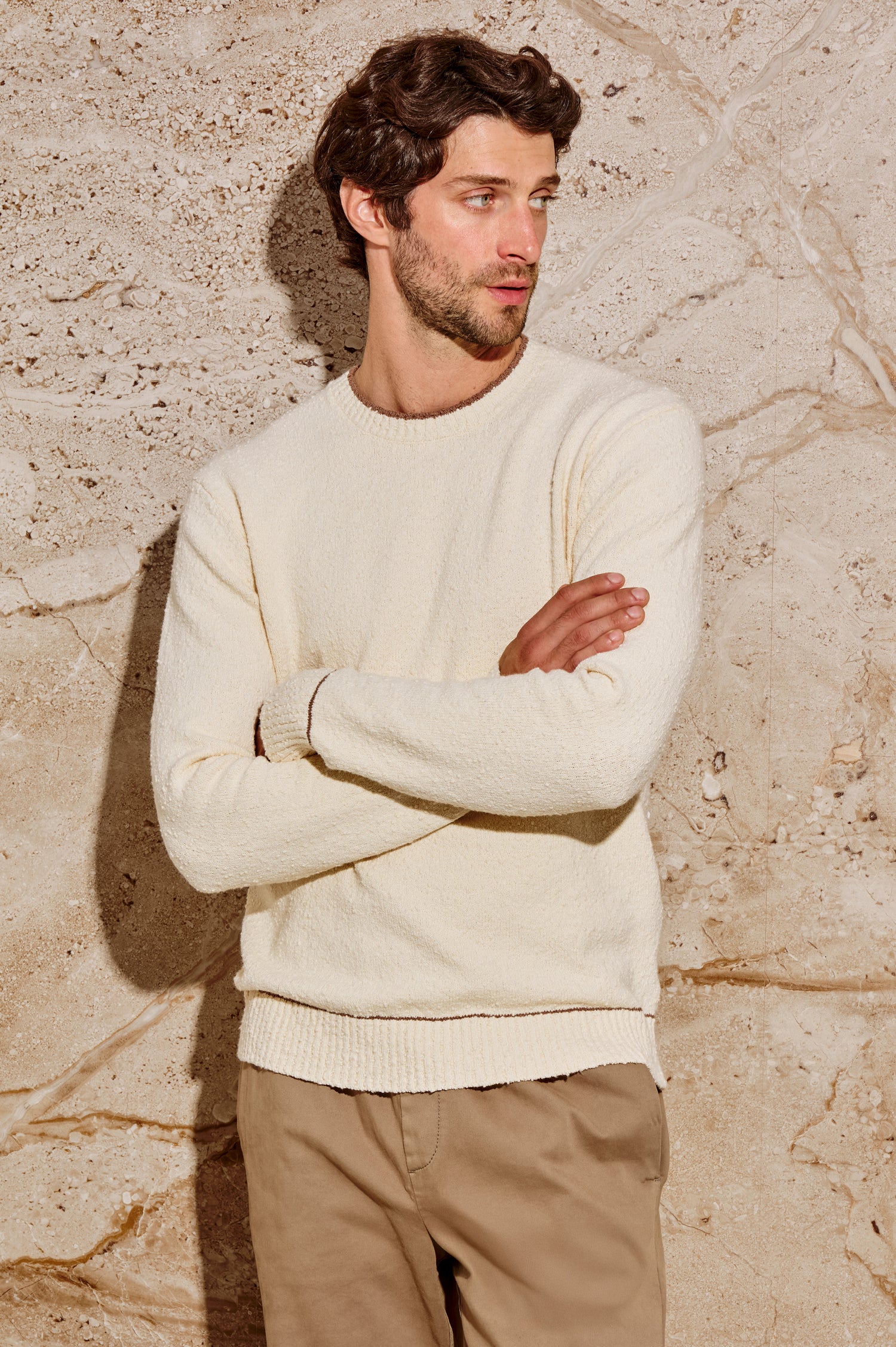 The Franco is a long sleeve crew neck sweater with contrast brown on neck, sleeve and hem in Cream colorway. Front view featured on model.