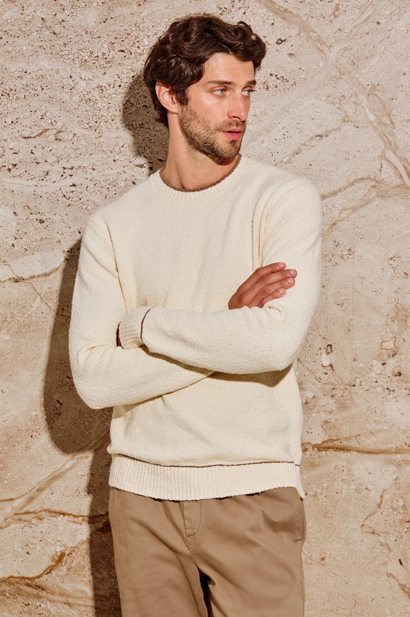 The Franco is a long sleeve crew neck sweater with contrast brown on neck, sleeve and hem in Cream colorway. Front view featured on model.