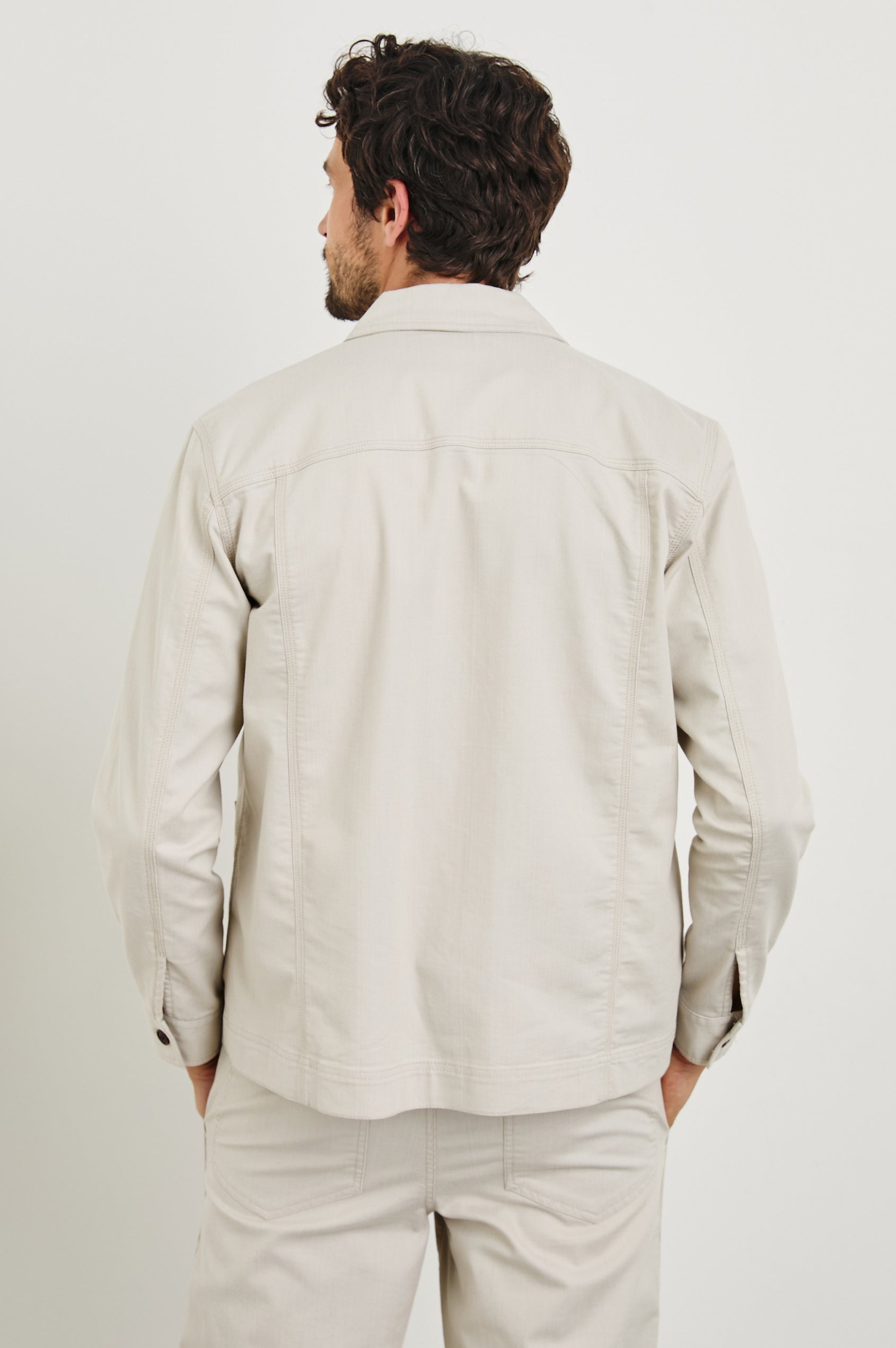 Franklin Jacket with Button Closure, Two Front Patch Pockets and Two Chest Button Flap Pockets in Oat Railroad Dobby Colorway - Back View Featured on Model