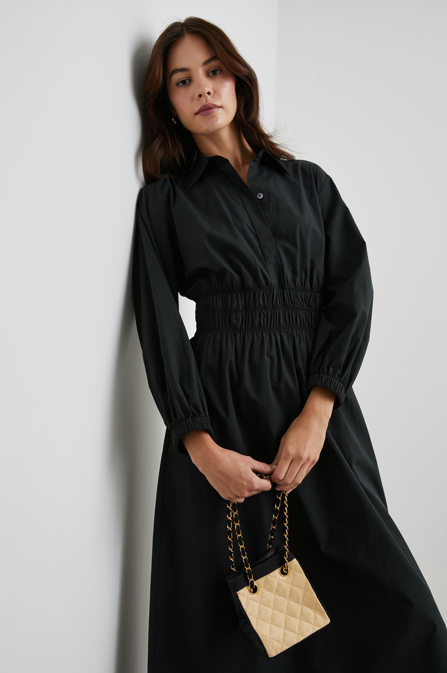 Fraya Long-Sleeve Midi Dress with a Concealed Button Placket on the Bodice, a Collar, a Shirred Waist, and Two Hip Pockets in Black Colorway - Front View Featured on Model 