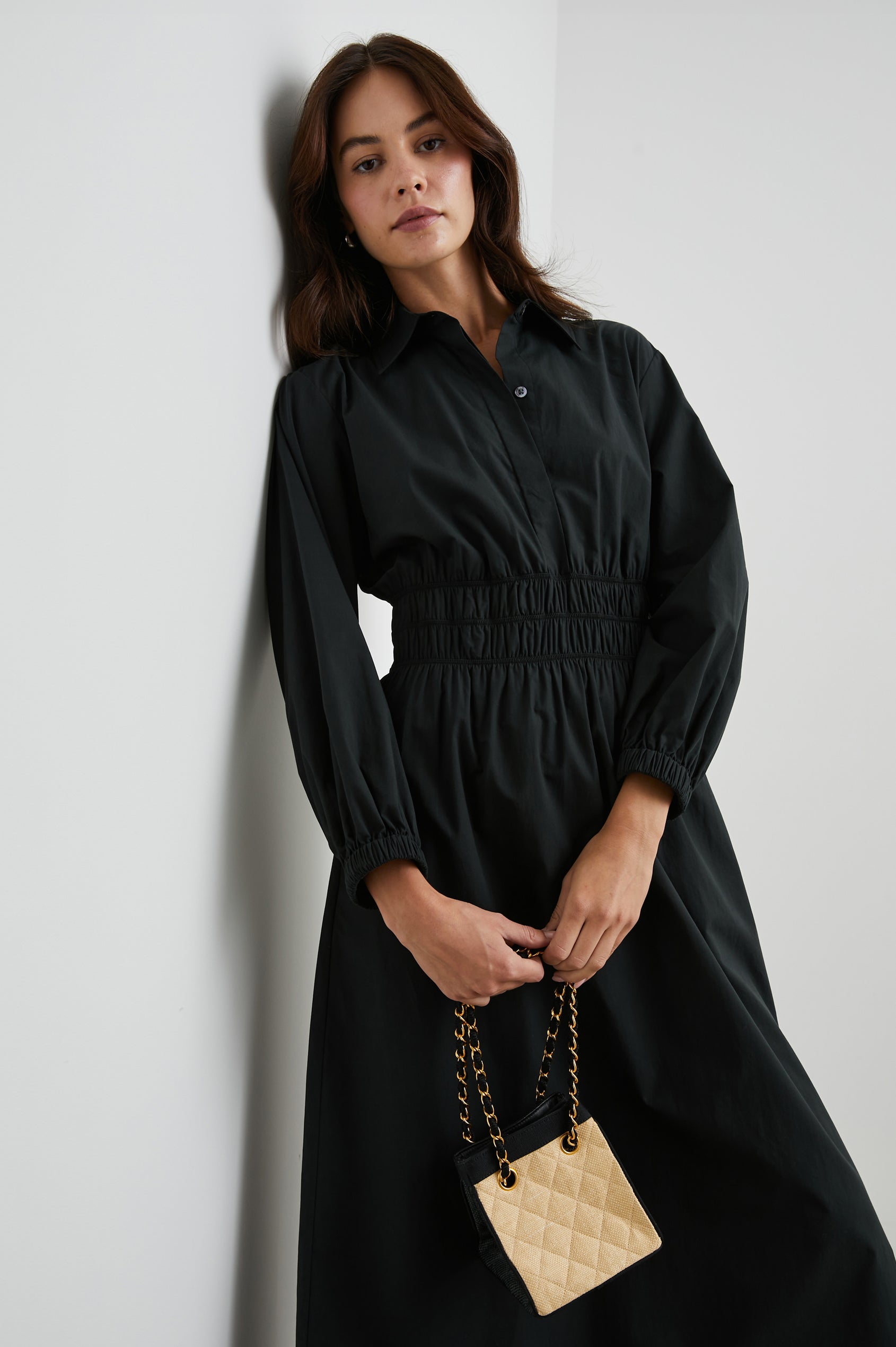 Fraya Long-Sleeve Midi Dress with a Concealed Button Placket on the Bodice, a Collar, a Shirred Waist, and Two Hip Pockets in Black Colorway - Front View Featured on Model 