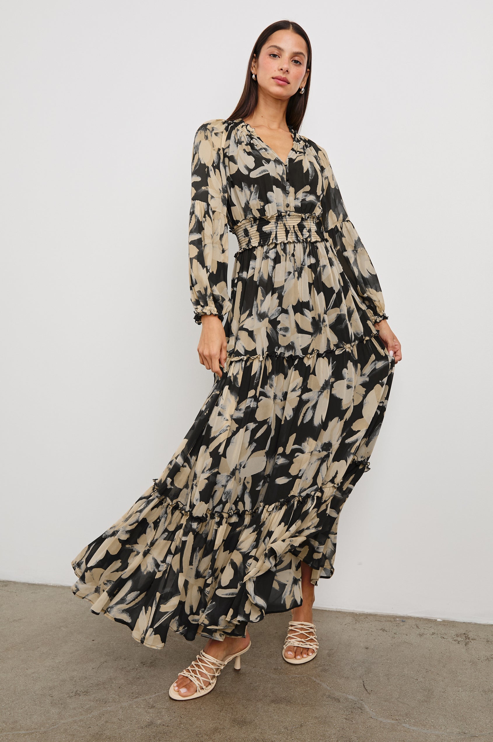 Frederica long sleeve flowy maxi dress with smocked neckline and waist and tiered skirt in Charcoal Lily - full body front view in motion