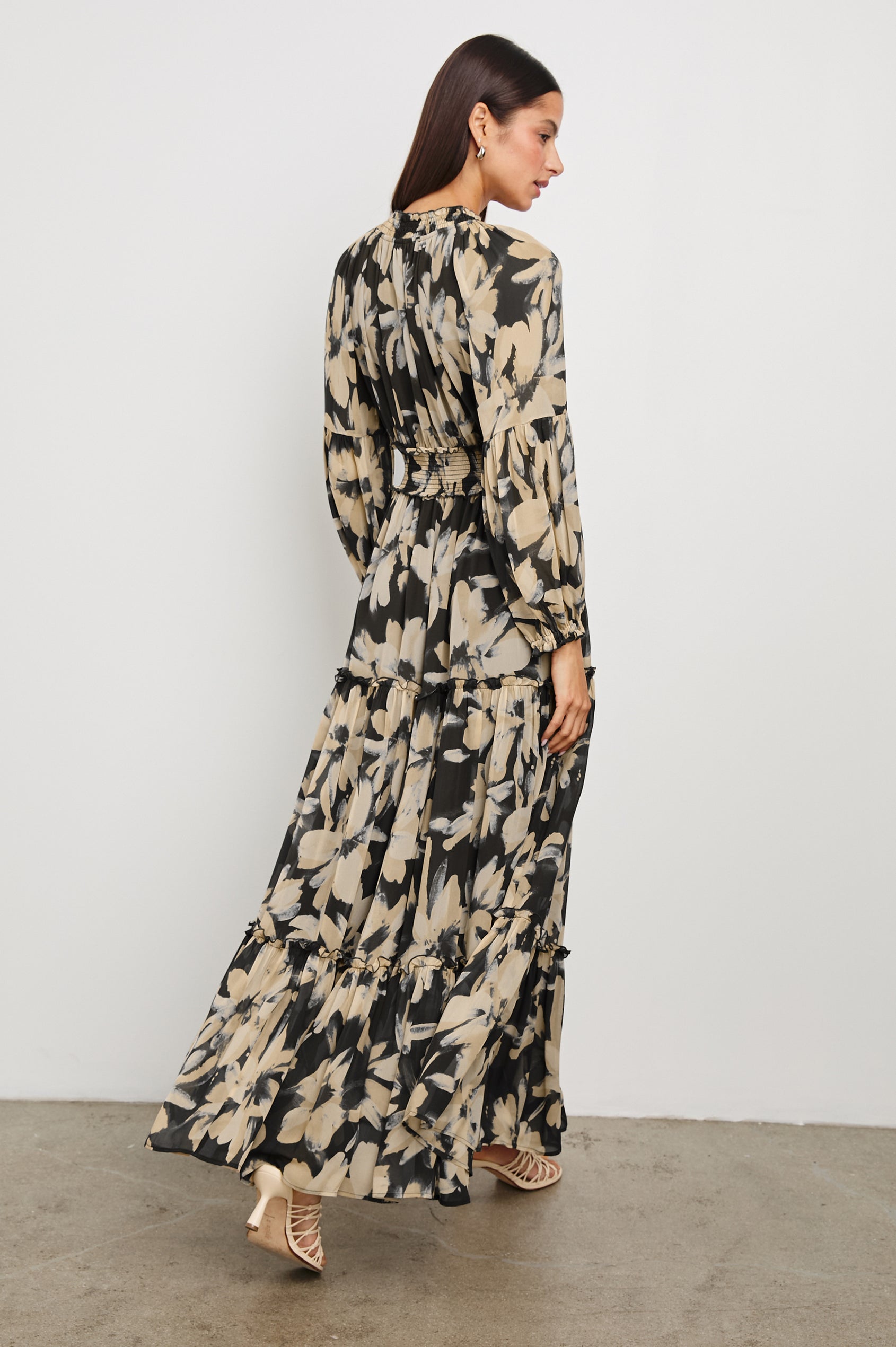 Frederica long sleeve flowy maxi dress with smocked neckline and waist and tiered skirt in Charcoal Lily - back view on model