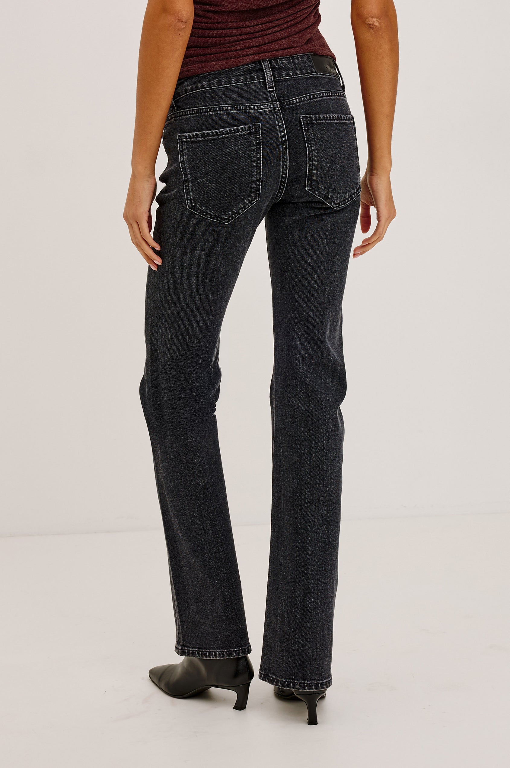 Fremont Low Rise Bootcut Jean in Light Stretch Denim With Extended Inseam, 5-Pockets, Belt Loops, and Zip-Fly Closure in Blackjack Colorway - Lower Body Back View Featured on Model