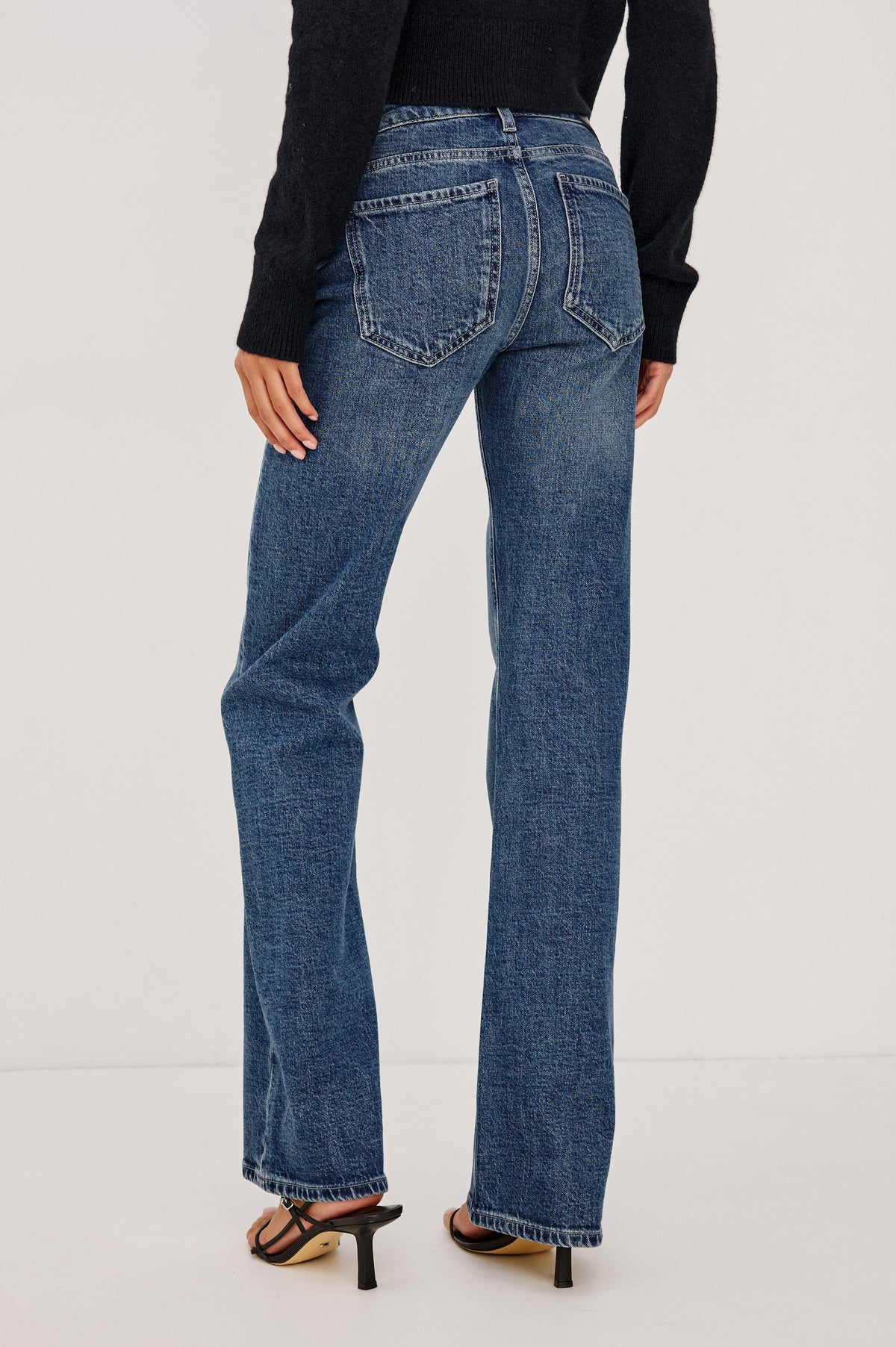 Fremont Low Rise Bootcut Jean in Light Stretch Denim With Extended Inseam, 5-Pockets, Belt Loops, and Zip-Fly Closure in Blue Haven Colorway - Upper Body Back View Featured on Model.