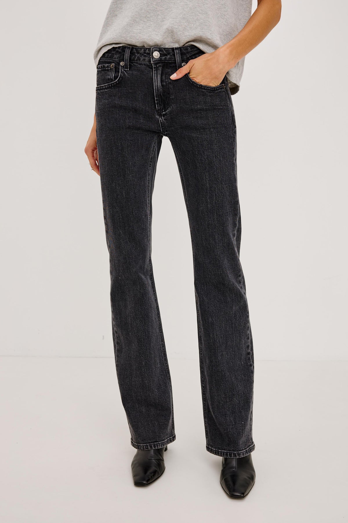 Fremont Petite Low Rise Bootcut Jean in Light Stretch Denim With Extended Inseam, 5-Pockets, Distressed Details, Belt Loops, and Zip-Fly Closure in Blackjack Colorway - Lower Body Front View Featured on Model