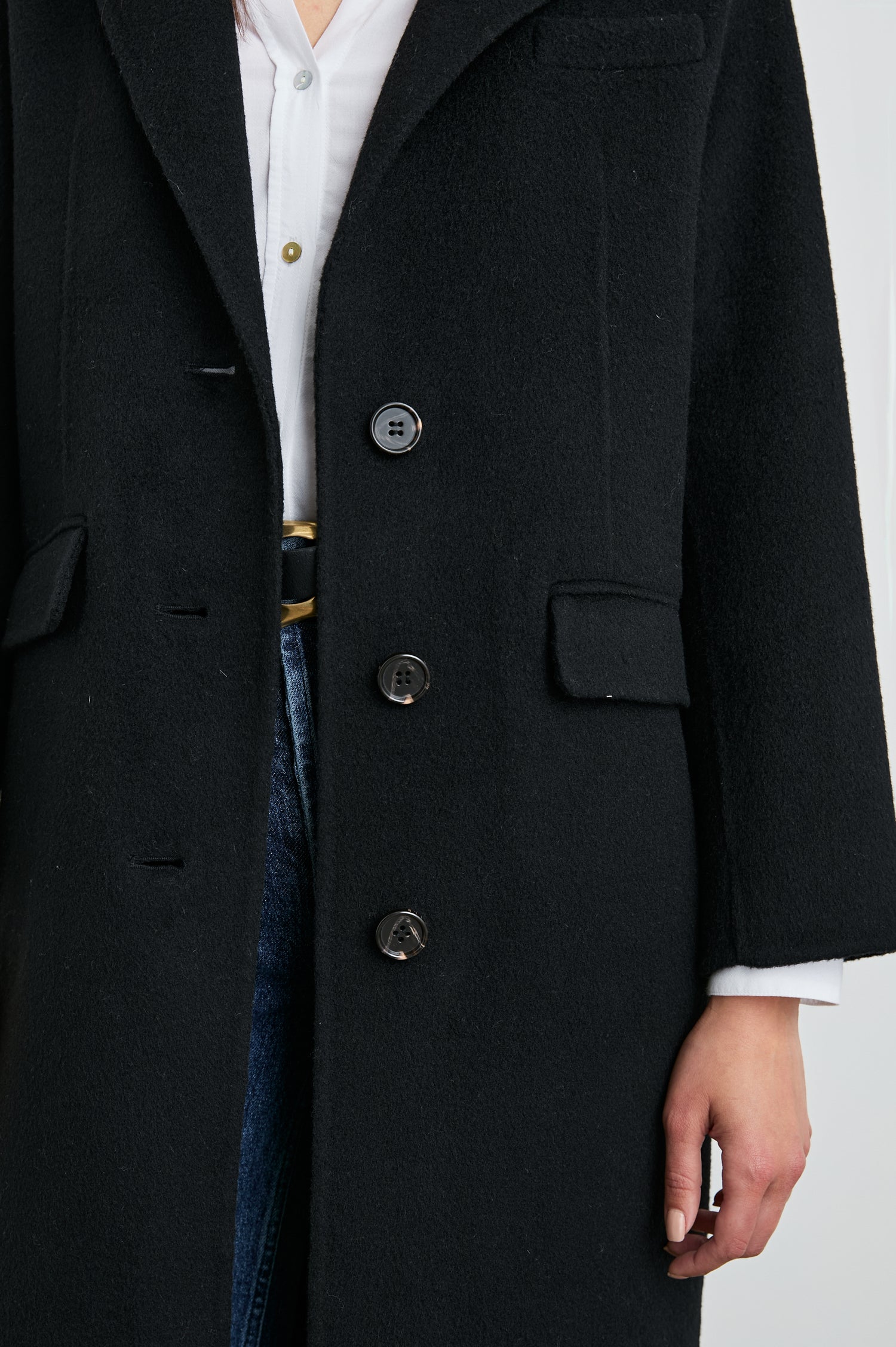 Gallery Below-the-Knee Coat with Three-Button Closure, Notched Lapels, and Two Front Flap Pockets in Black Colorway - Front View Featured on Model