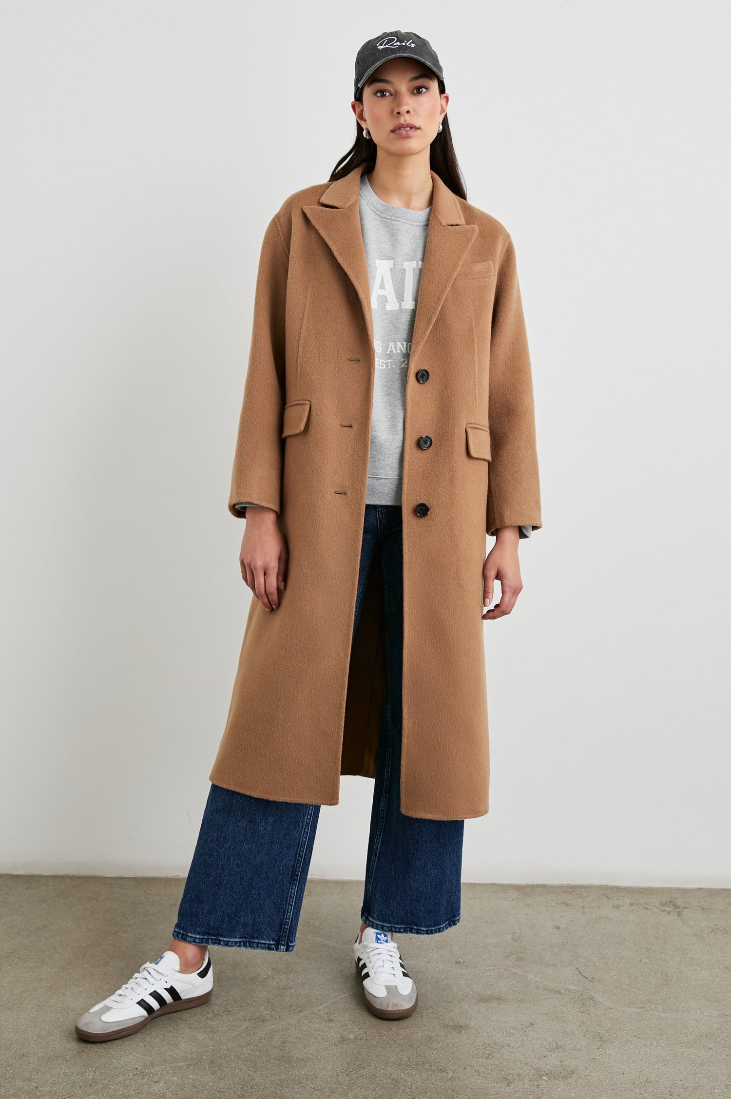 Gallery Below-the-Knee Coat with Three-Button Closure, Notched Lapels, and Two Front Flap Pockets in Camel Colorway - Front Full Body View Featured on Model