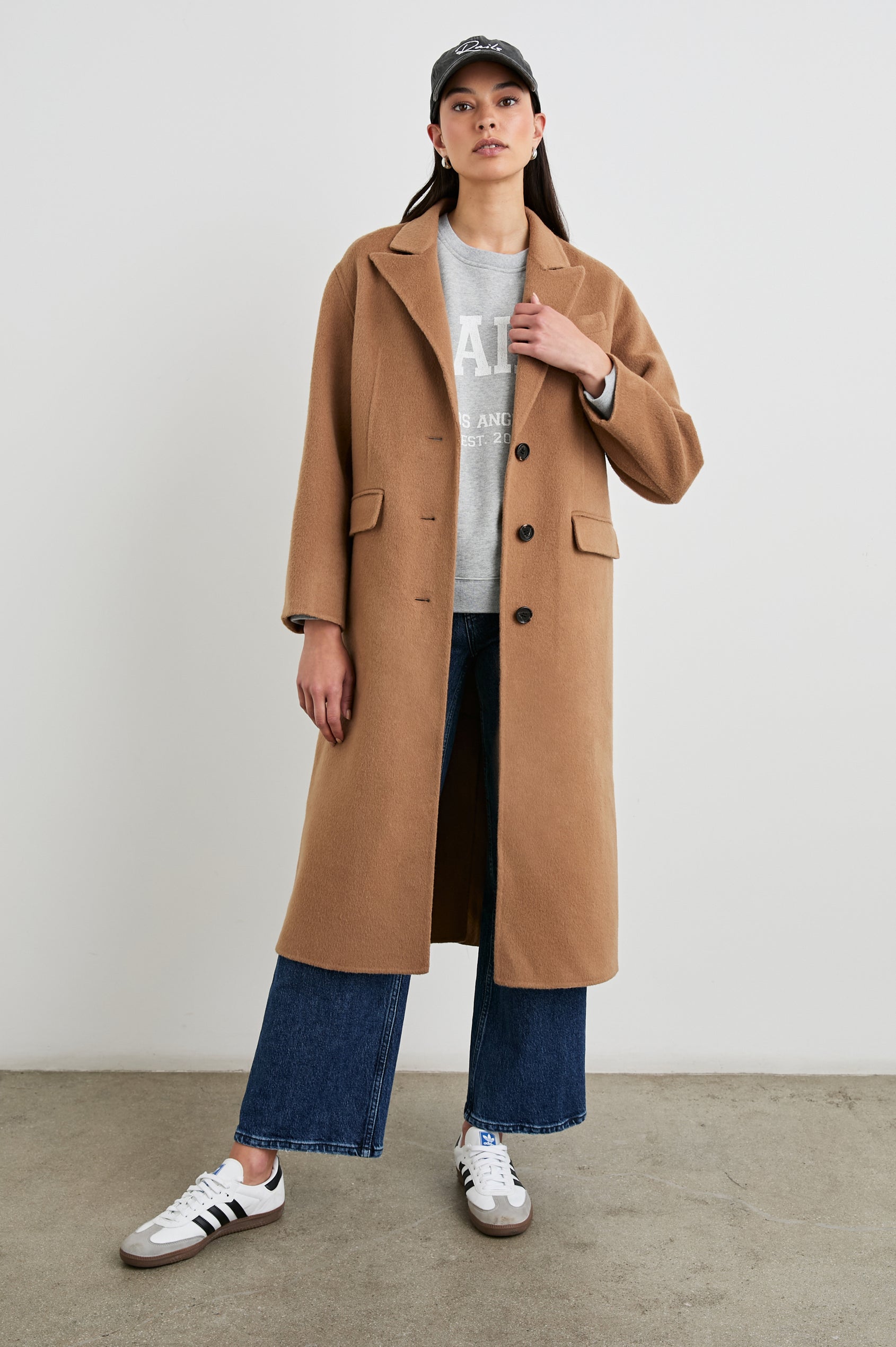 Gallery Below-the-Knee Coat with Three-Button Closure, Notched Lapels, and Two Front Flap Pockets in Camel Colorway - Front Full Body View Featured on Model