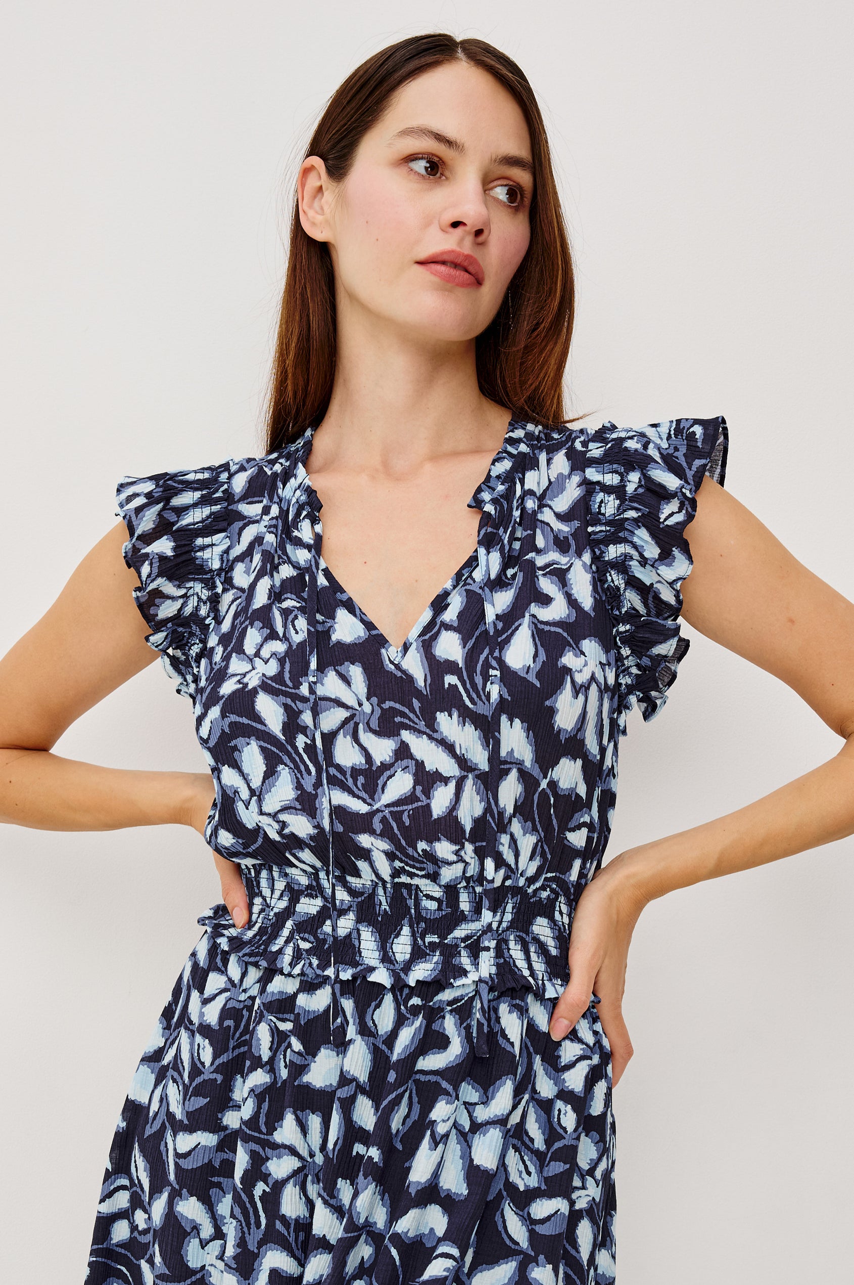 Garden Peasant Floral Midi Dress in Linen With Ruffle Flutter Sleeves, Center Front Ties, V-Neckline, Shirred Waist, and Relaxed Fit in Navy Jasmine Colorway - Upper Body Front View Featured on Model