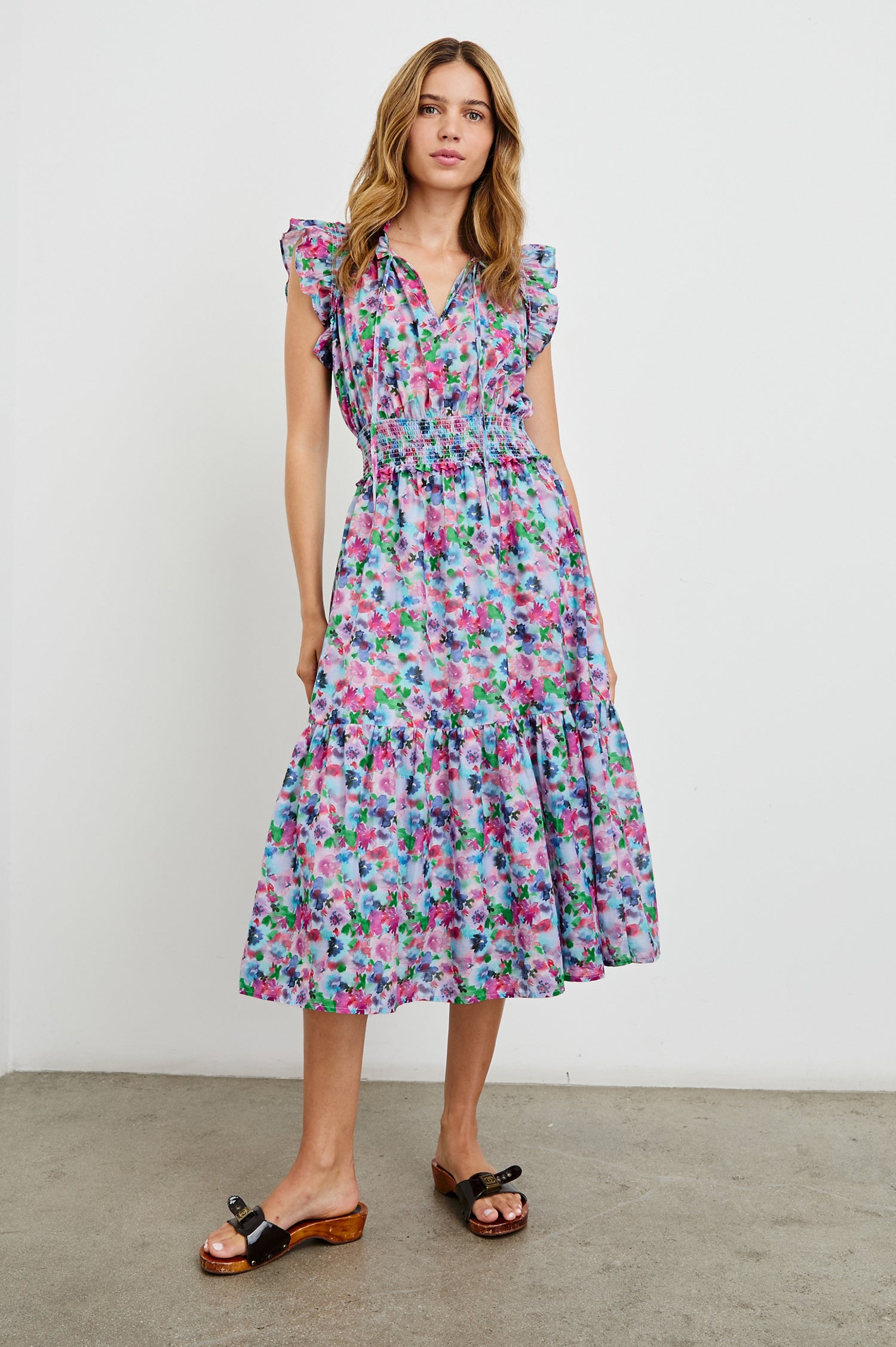 Garden Midi Dress with Flutter Cap Sleeves, Drawstrings at Neck and Shirred Waistband in Spring Meadow Colorway, Flowers in Pinks, Blues and Green - Front Full Body View Featured on Model