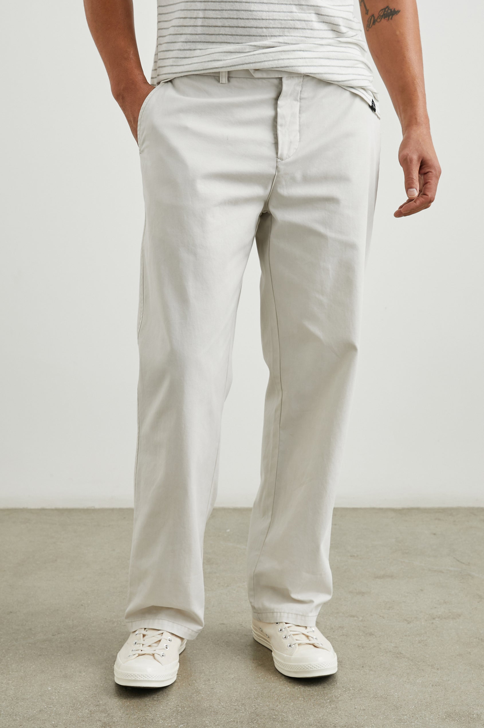 Garrett Pants with a Button Strap Closure at the Waist, Belt Loops, Two Front Pockets and Two Back Button Welt Pockets in Stone Colorway - Front View Featured on Model
