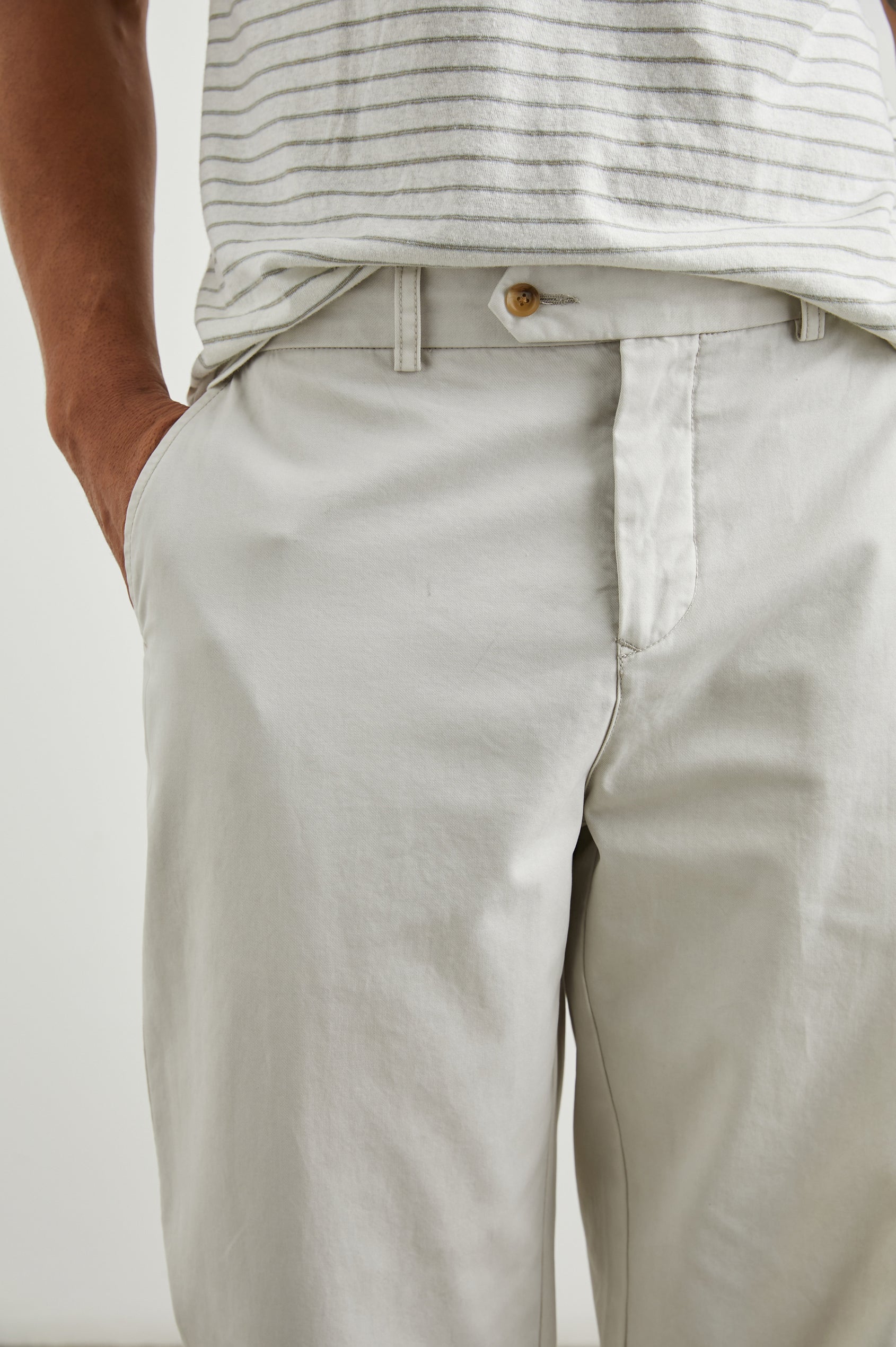 Garrett Pants with a Button Strap Closure at the Waist, Belt Loops, Two Front Pockets and Two Back Button Welt Pockets in Stone Colorway - Front View Featured on Model