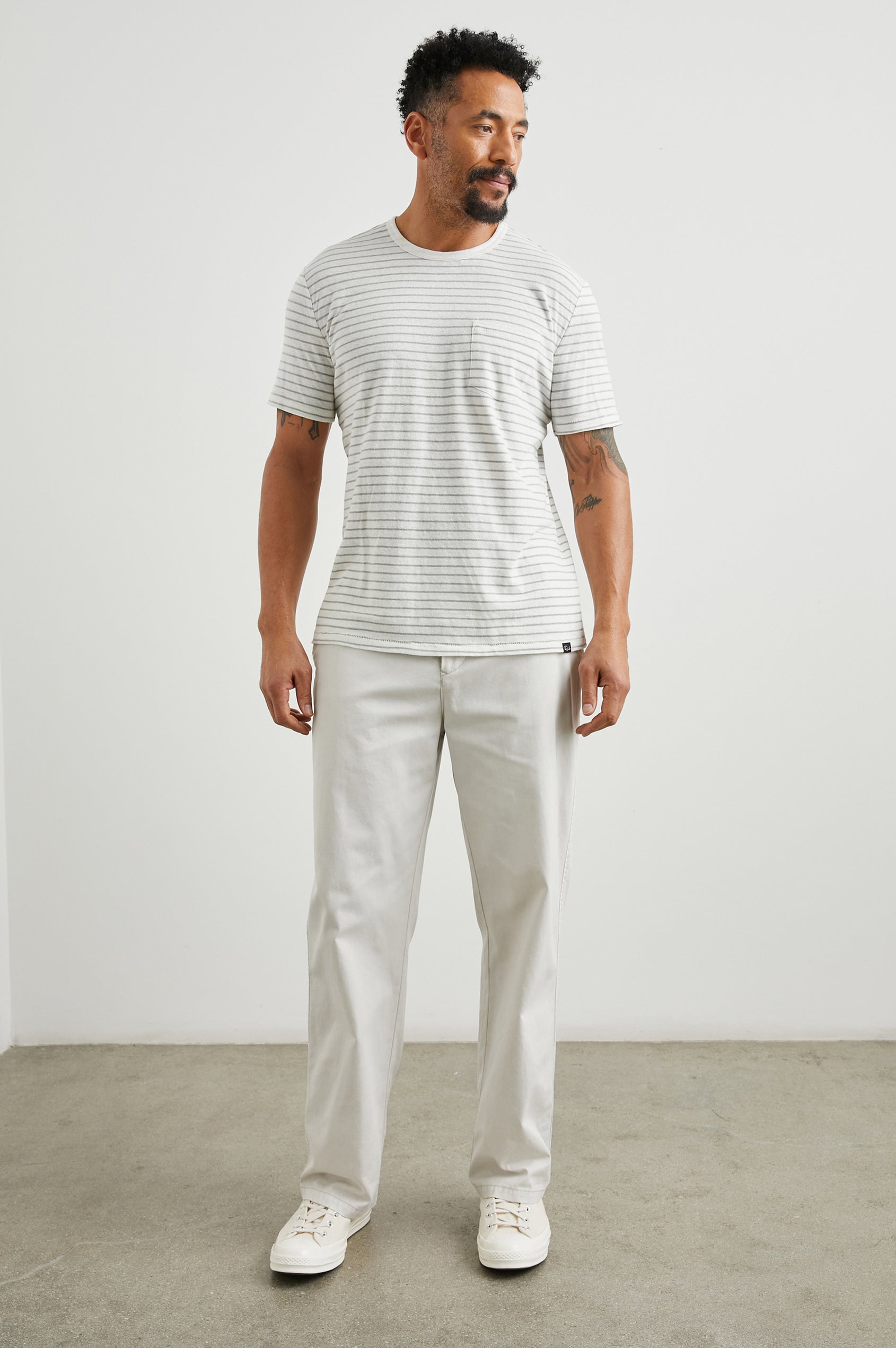 Garrett Pants with a Button Strap Closure at the Waist, Belt Loops, Two Front Pockets and Two Back Button Welt Pockets in Stone Colorway - Front Full Body View Featured on Model