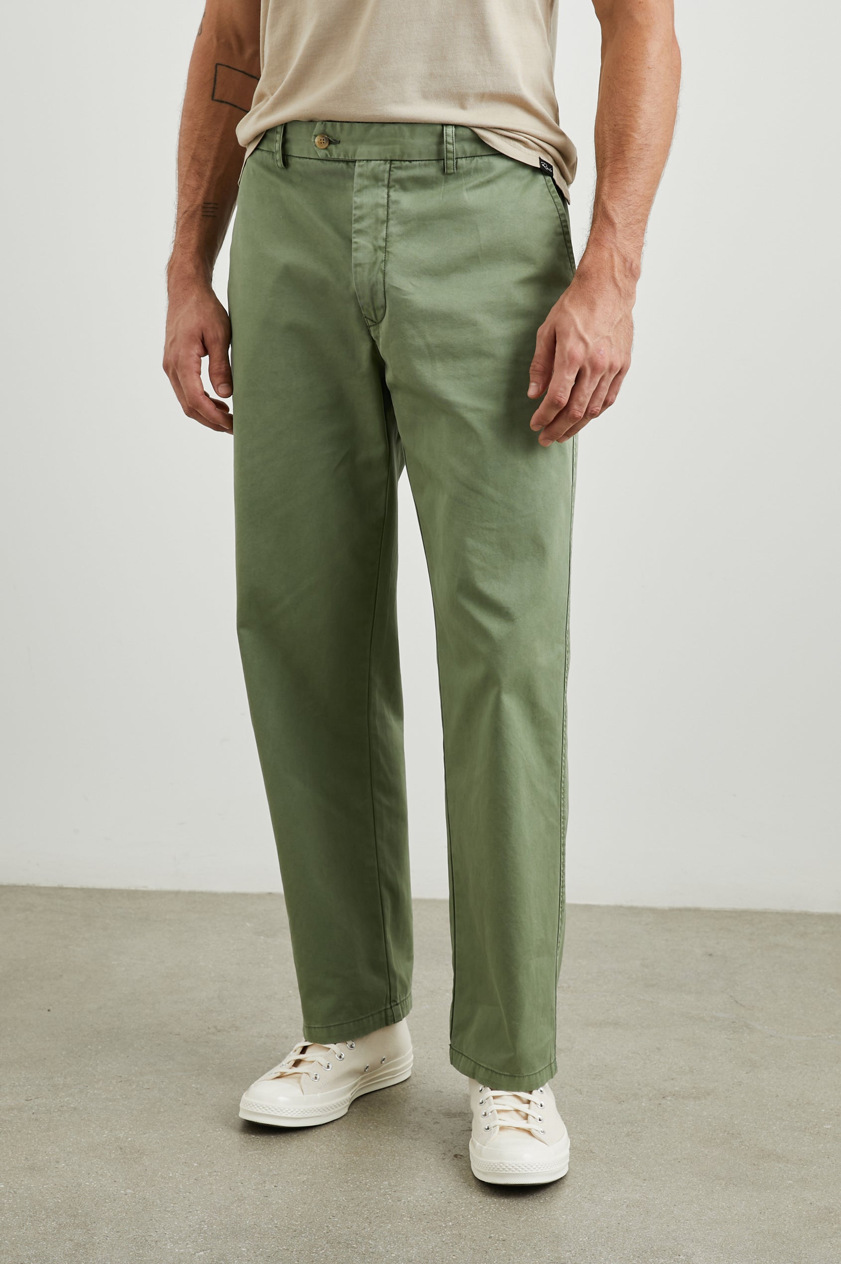 Garrett Pants with a Button Strap Closure at the Waist, Belt Loops, Two Front Pockets and Two Back Button Welt Pockets in Spring Olive Colorway - Front View Featured on Model