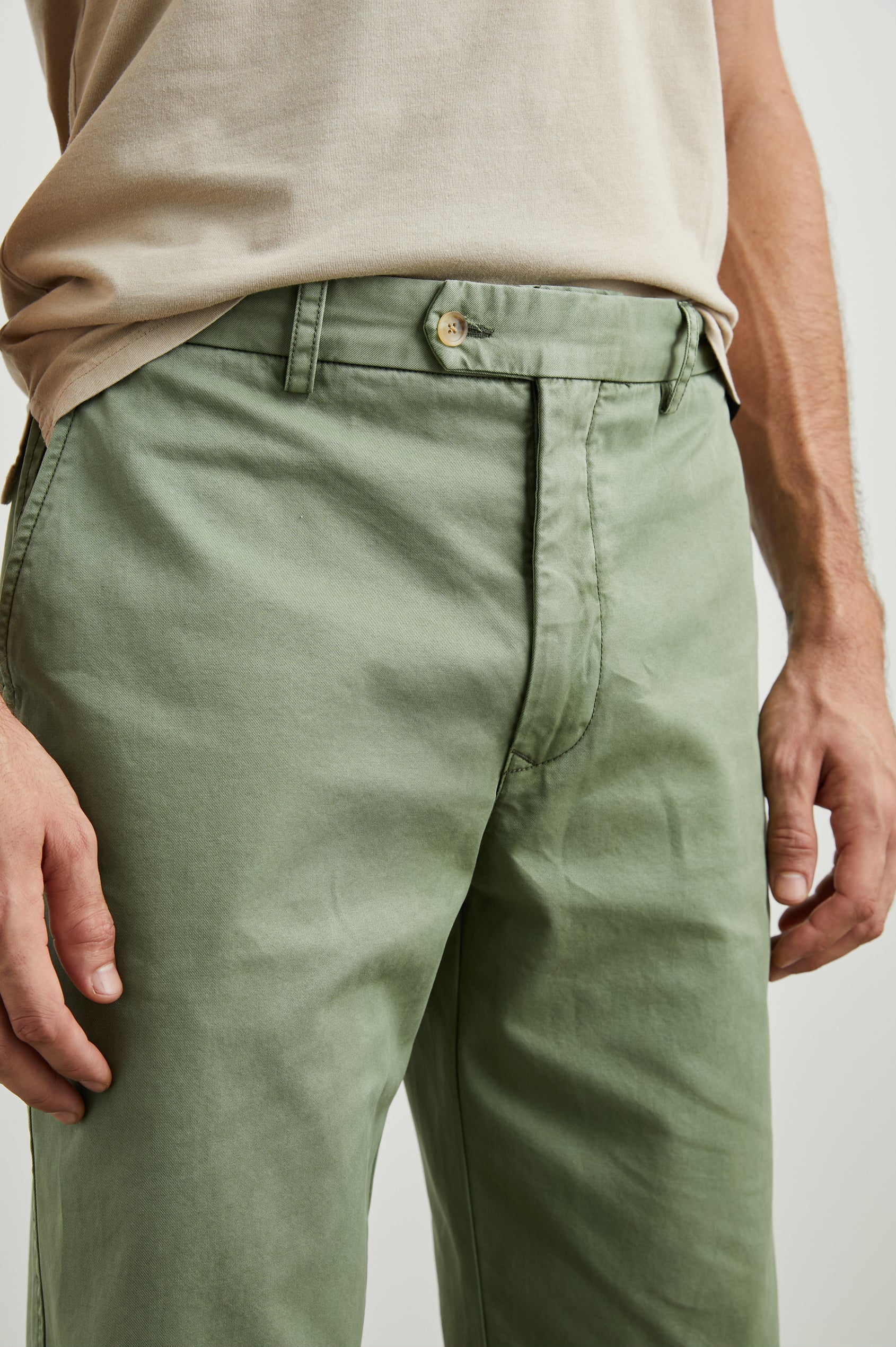 Garrett Pants with a Button Strap Closure at the Waist, Belt Loops, Two Front Pockets and Two Back Button Welt Pockets in Spring Olive Colorway - Front View Featured on Model