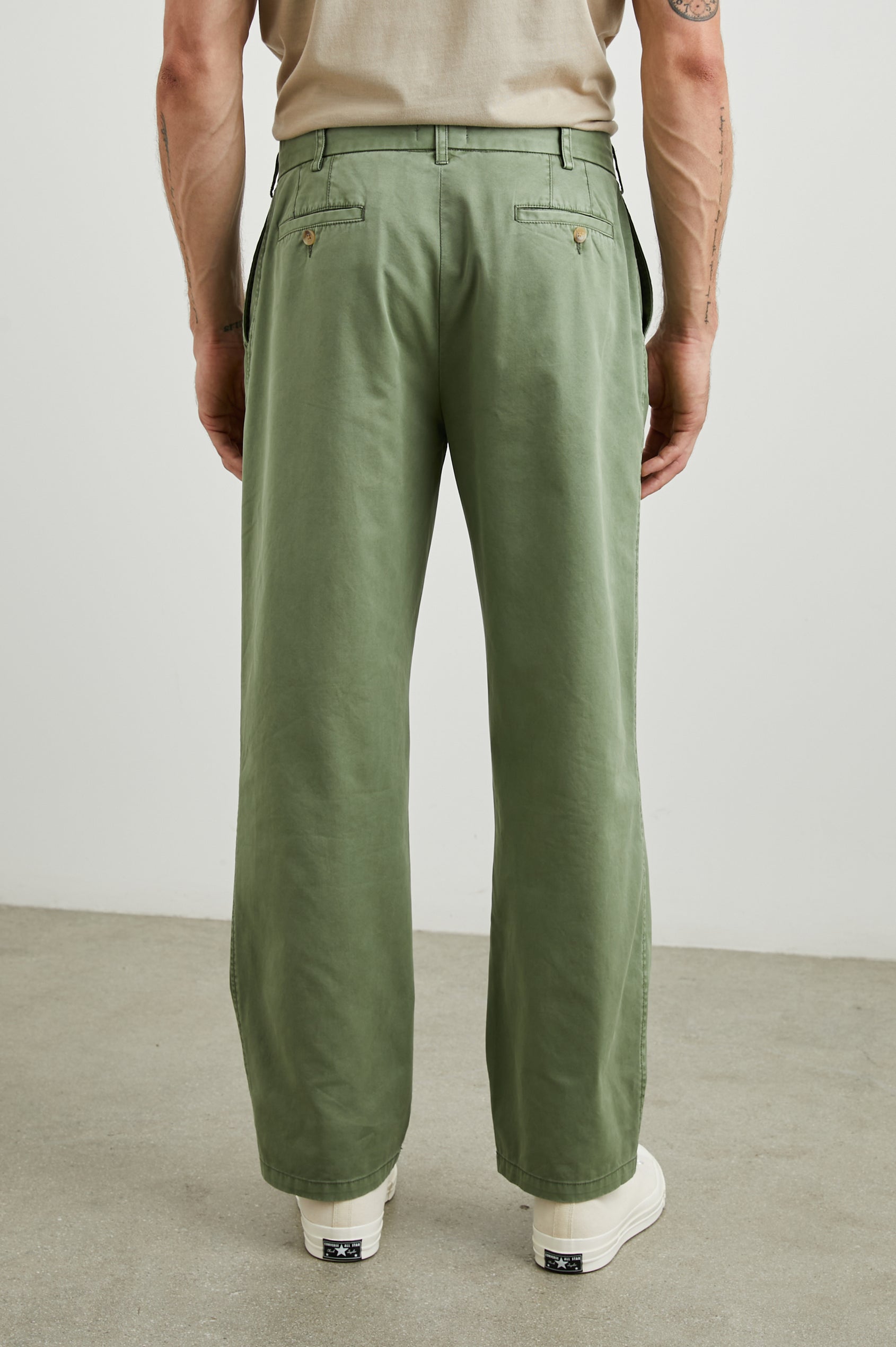 Garrett Pants with a Button Strap Closure at the Waist, Belt Loops, Two Front Pockets and Two Back Button Welt Pockets in Spring Olive Colorway - Back View Featured on Model