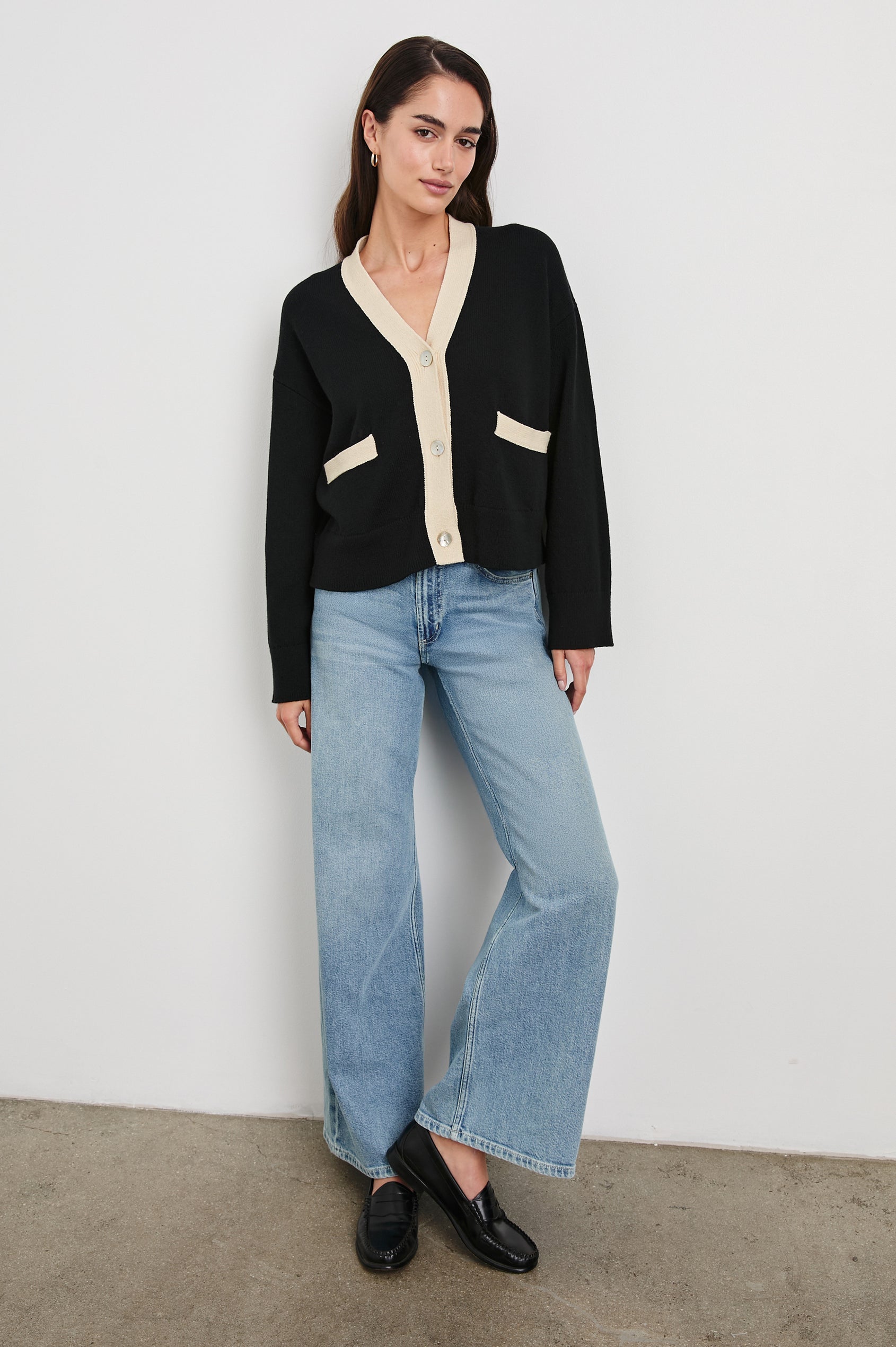 Geneva Long-Sleeve Cardigan with Two Front Patch Pockets and Button Closure in Black Ivory Colorway, with Ivory neckline, closure and pocket openings on Black - Front Full Body View Featured on Model