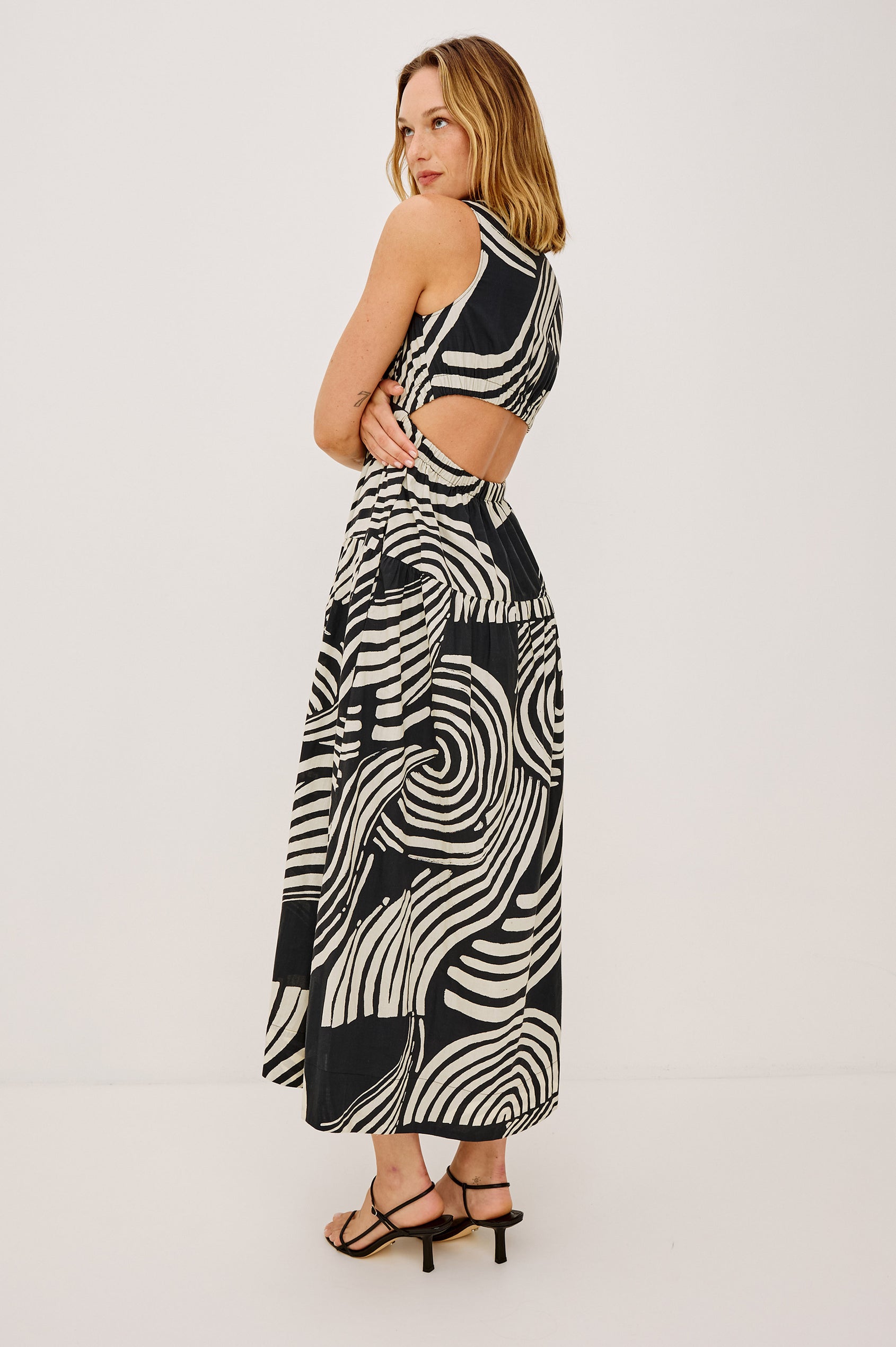 Genevieve Maxi Dress in Cotton Voile With A-Line Silhouette, V-Neckline, Wide Elastic Underbust, Back Cutout, Full Lining, and Side Pockets in Onyx Waves Colorway - Full Body Back View Featured on Model