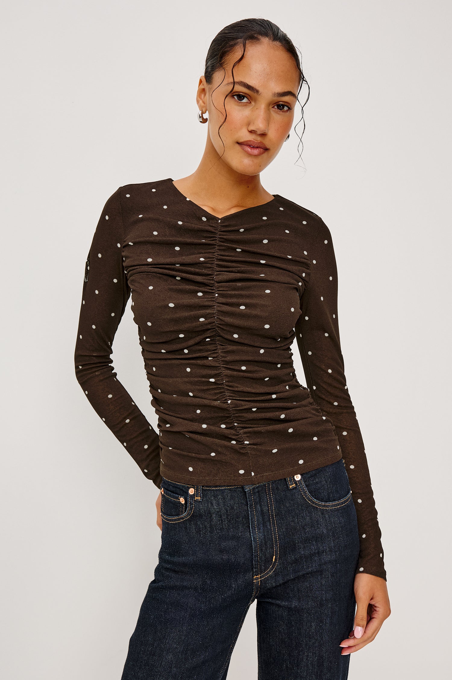Georgina Fitted Top in Stretch Mesh With Front Shirring, Long Sleeves, and Subtle V-Neckline in Cocoa Polka Dots Colorway - Upper Body Front View Featured on Model
