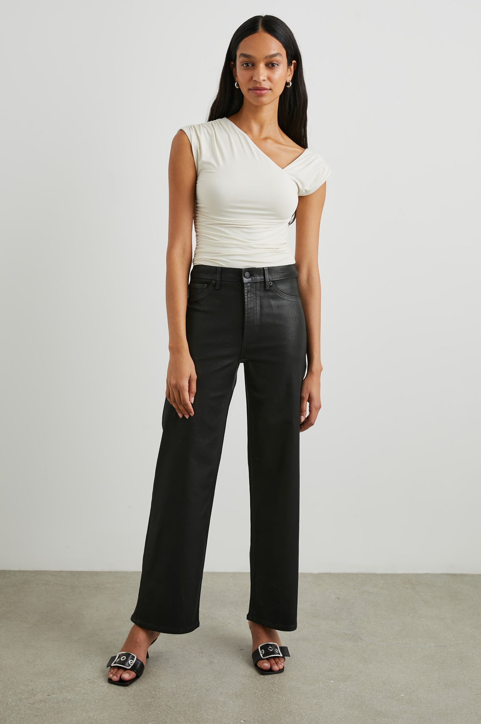 Getty Wide Leg Denim Pants with Belt Loops, Two Front Pockets and Two Back Patch Pockets in Coated Noir Colorway, with a black coating - Front Full Body View Featured on Model
