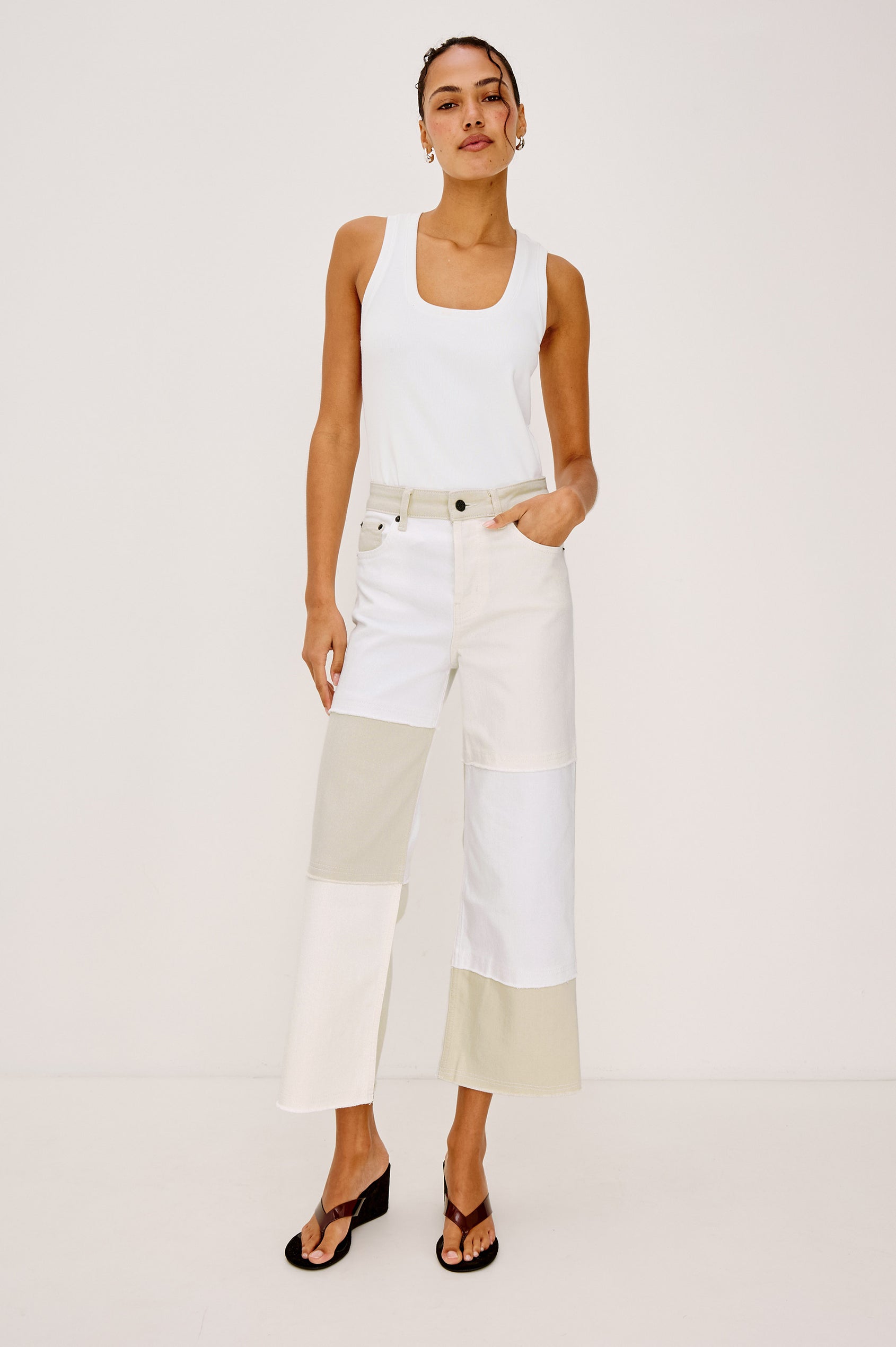 Getty Crop 5-Pocket Denim Pant with Tonal constrast from Panels with raw edges, Traditional Zip and Button Fly and Belt Loops in Ecru Patchwork Colorway. Full Body Front View Shown on Model.