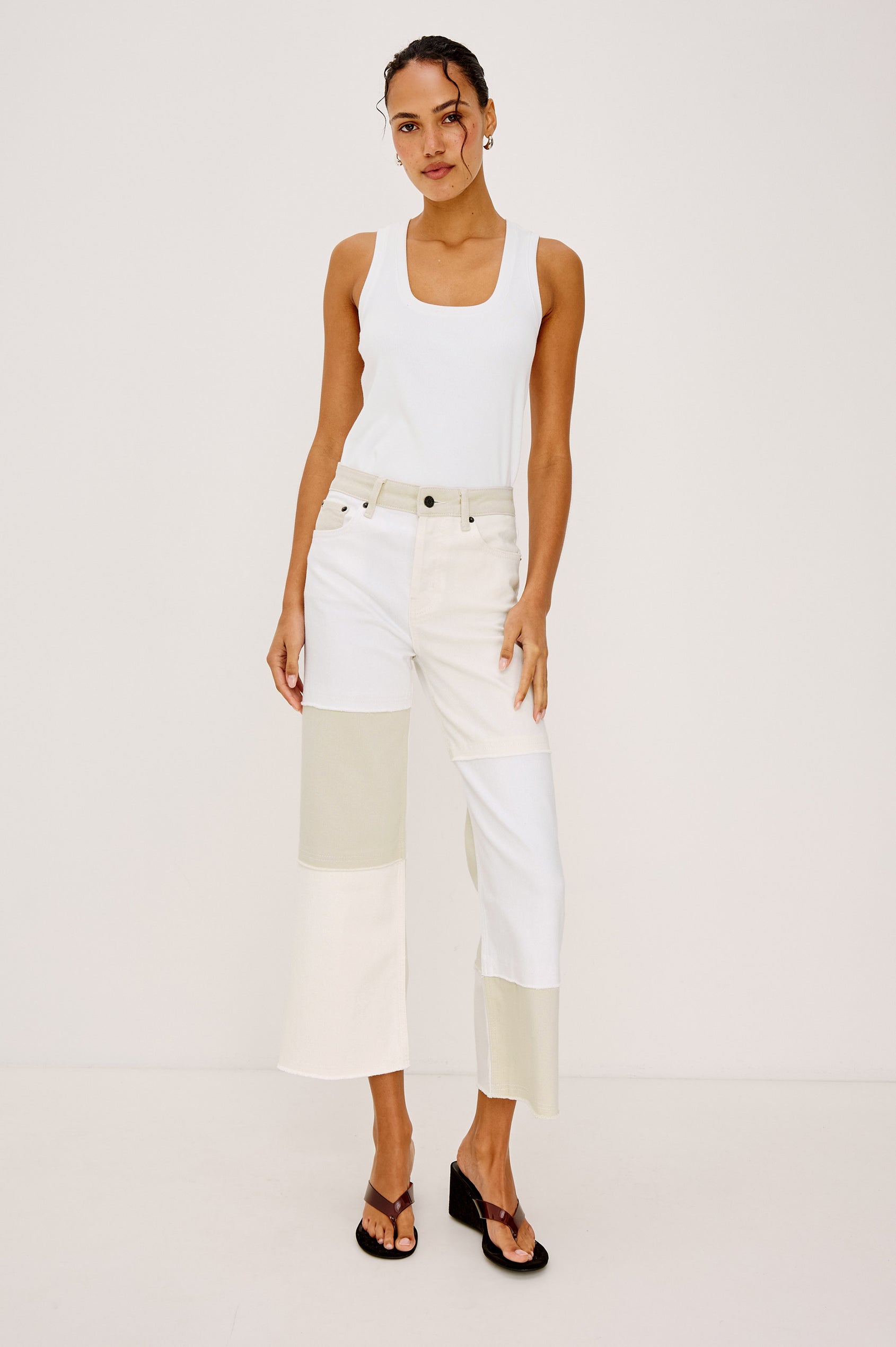 Getty Crop 5-Pocket Denim Pant with Tonal constrast from Panels with raw edges, Traditional Zip and Button Fly and Belt Loops in Ecru Patchwork Colorway. Front View Shown on Model.