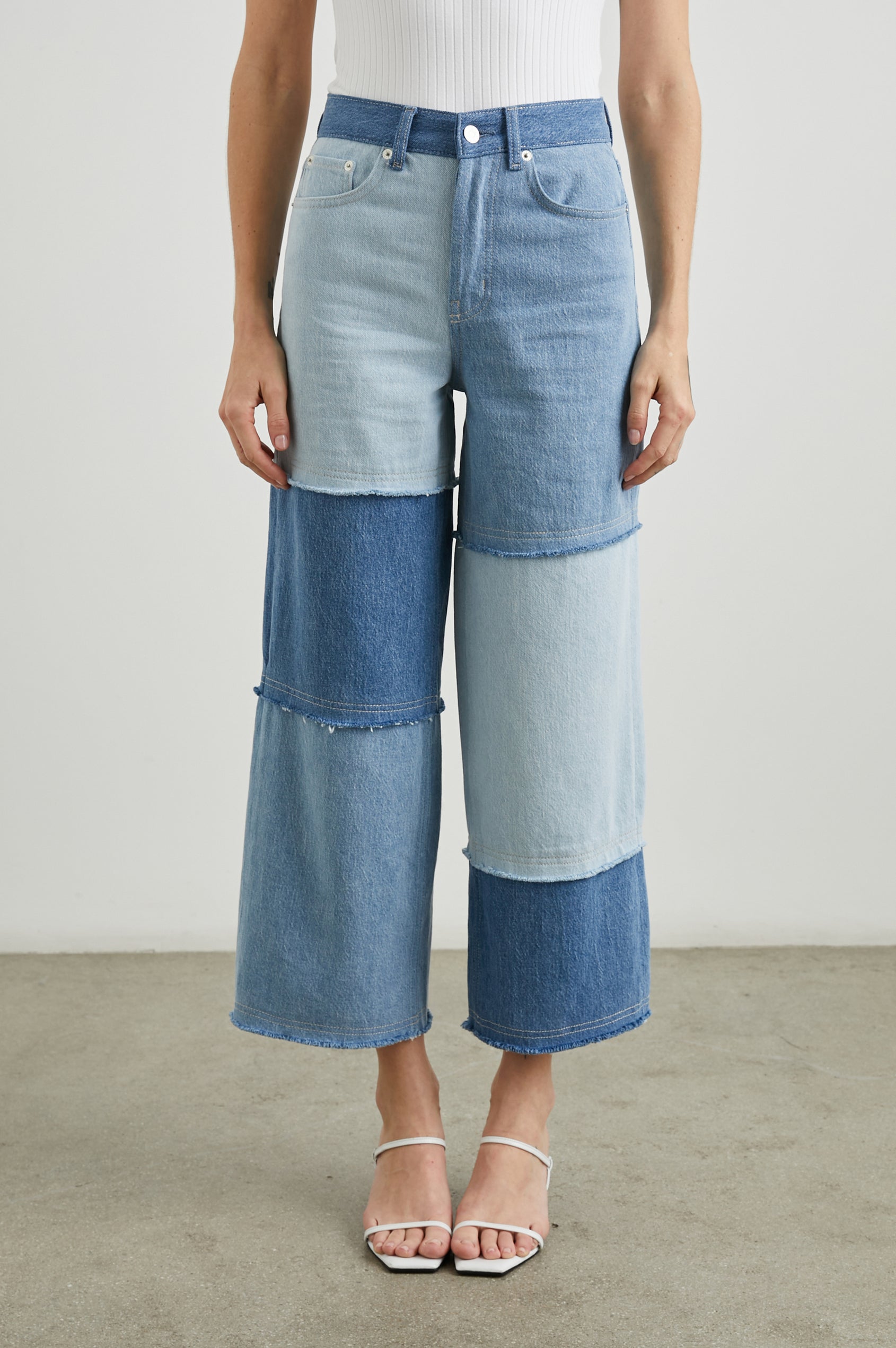 Getty Crop Wide Leg Denim Pants with Belt Loops, Two Front Pockets and Two Back Patch Pockets in Light Indigo Patchwork Colorway, with large patches in blues - Front View Featured on Model