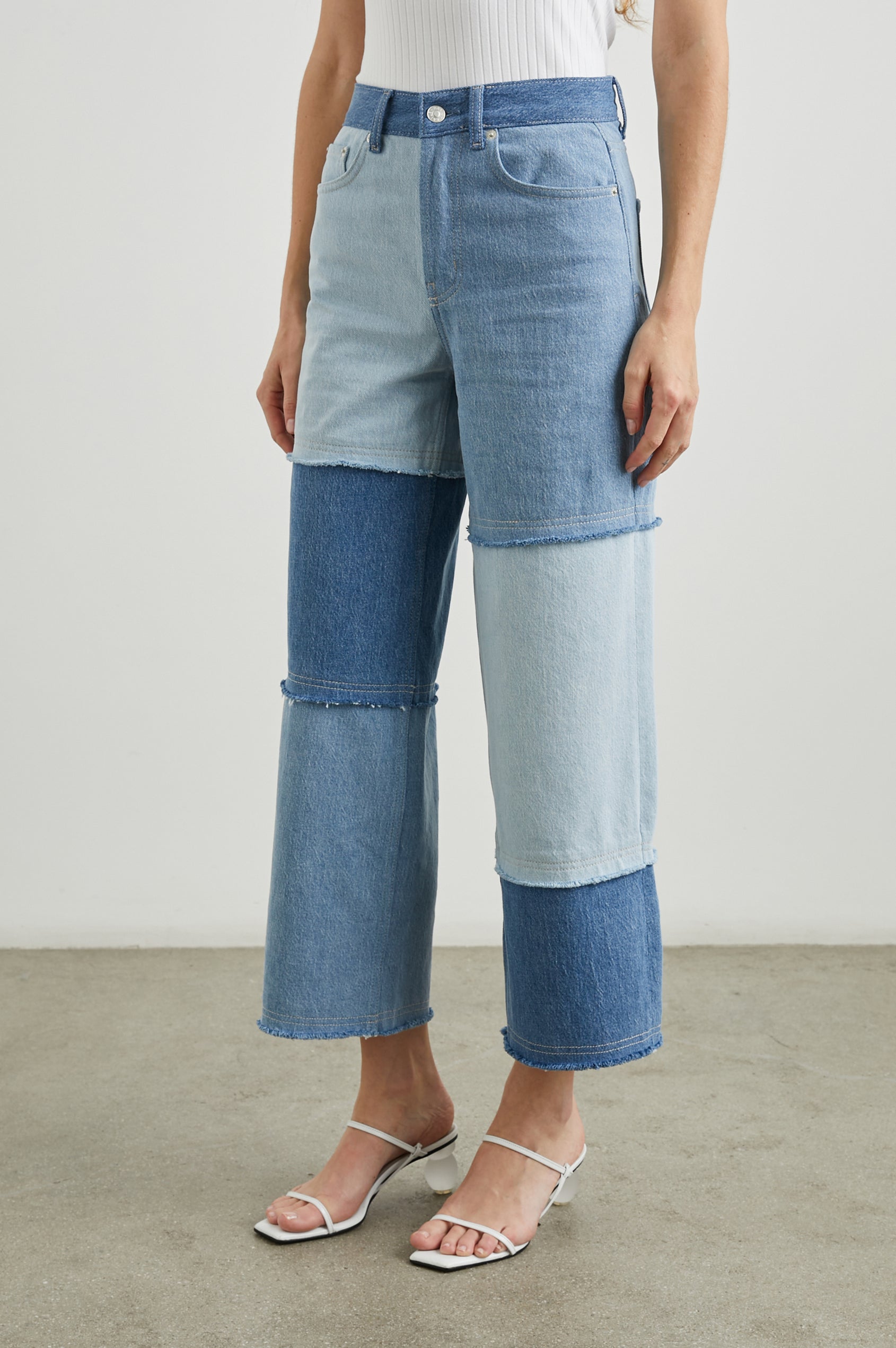 Getty Crop Wide Leg Denim Pants with Belt Loops, Two Front Pockets and Two Back Patch Pockets in Light Indigo Patchwork Colorway, with large patches in blues - Front View Featured on Model
