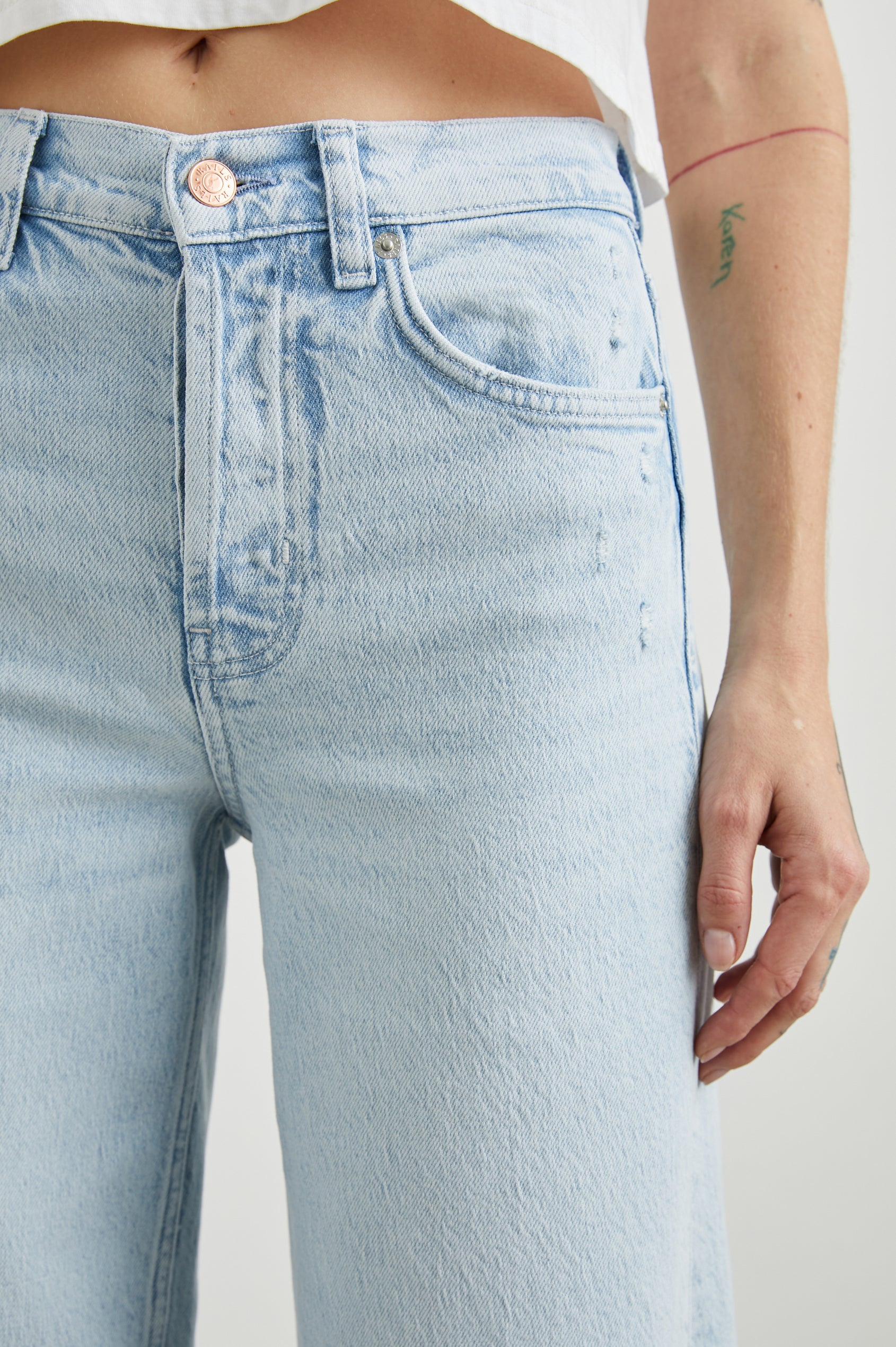 Getty Crop Wide Leg Denim Pants with Belt Loops, Fraying Near the Pockets, Two Front Pockets and Two Back Patch Pockets in Ocean Breeze Distress Colorway - Front View Featured on Model