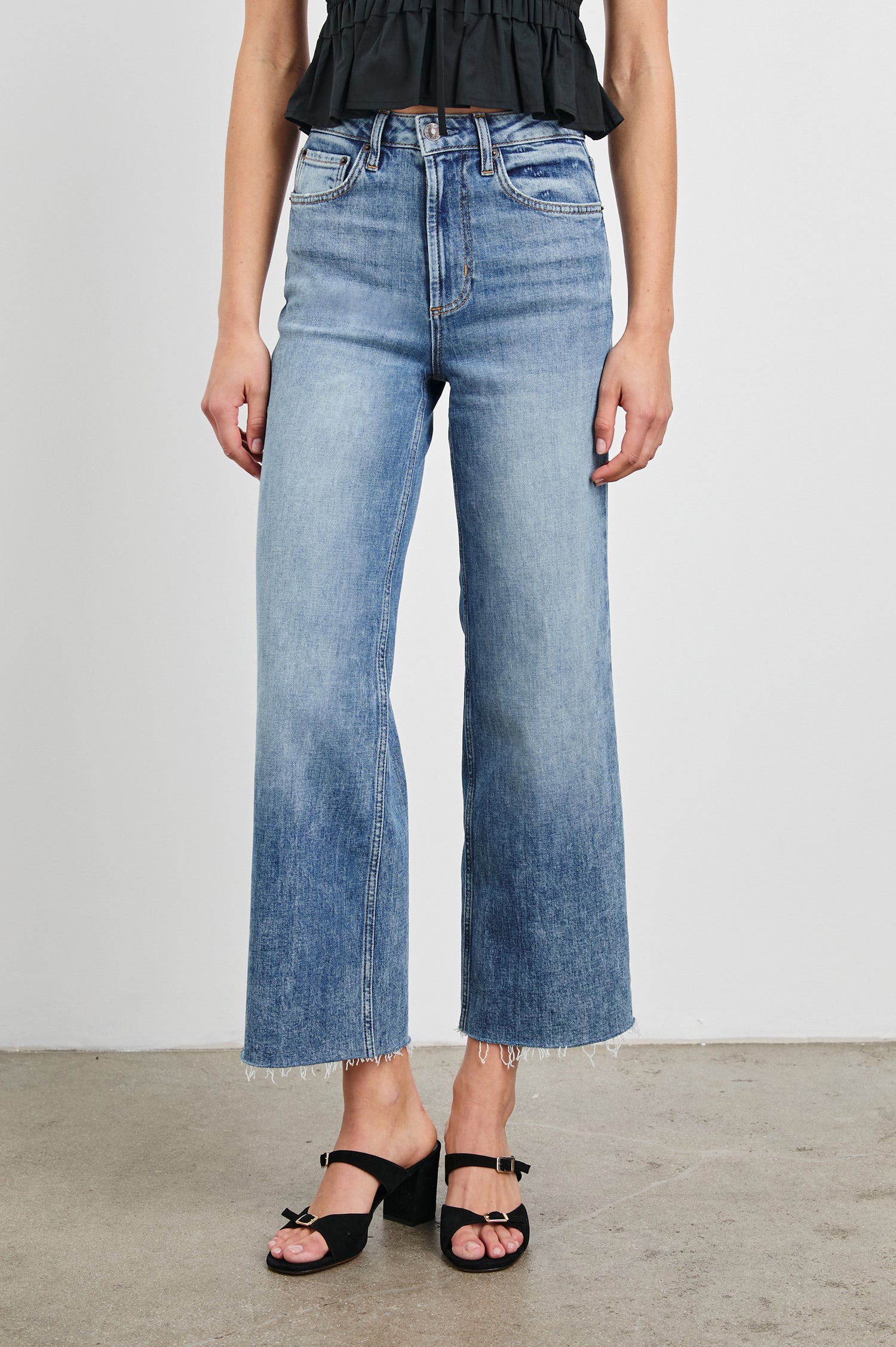 Getty cropped 5-pocket wide leg jean with in Tradewind, a medium wash. Front view featured on model.