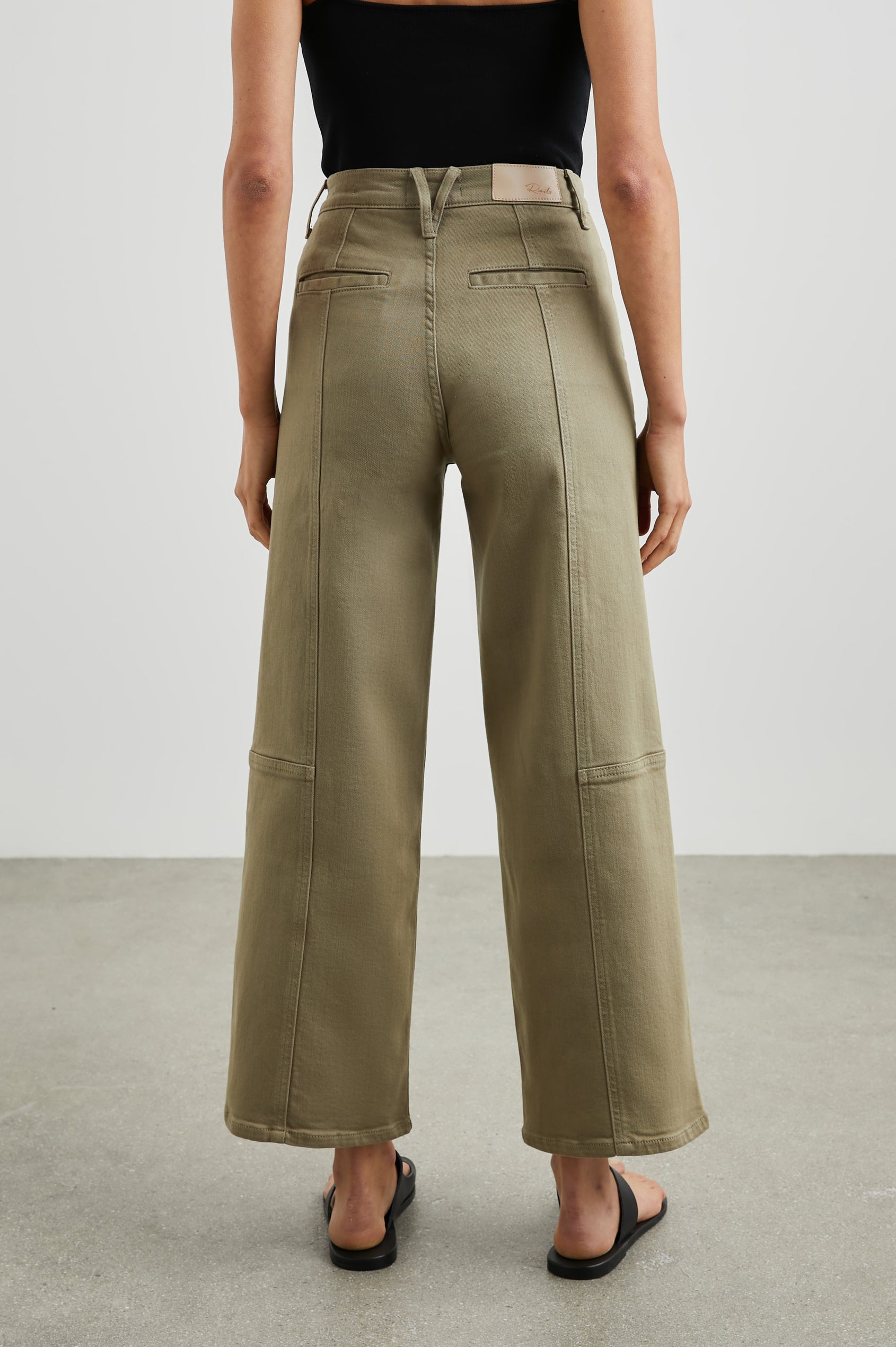 Getty Crop Utility Wide Leg Denim Pants with Belt Loops, Additional Seams, Two large Front Pockets and Two Back Patch Pockets in Washed Olive Colorway - Back View Featured on Model