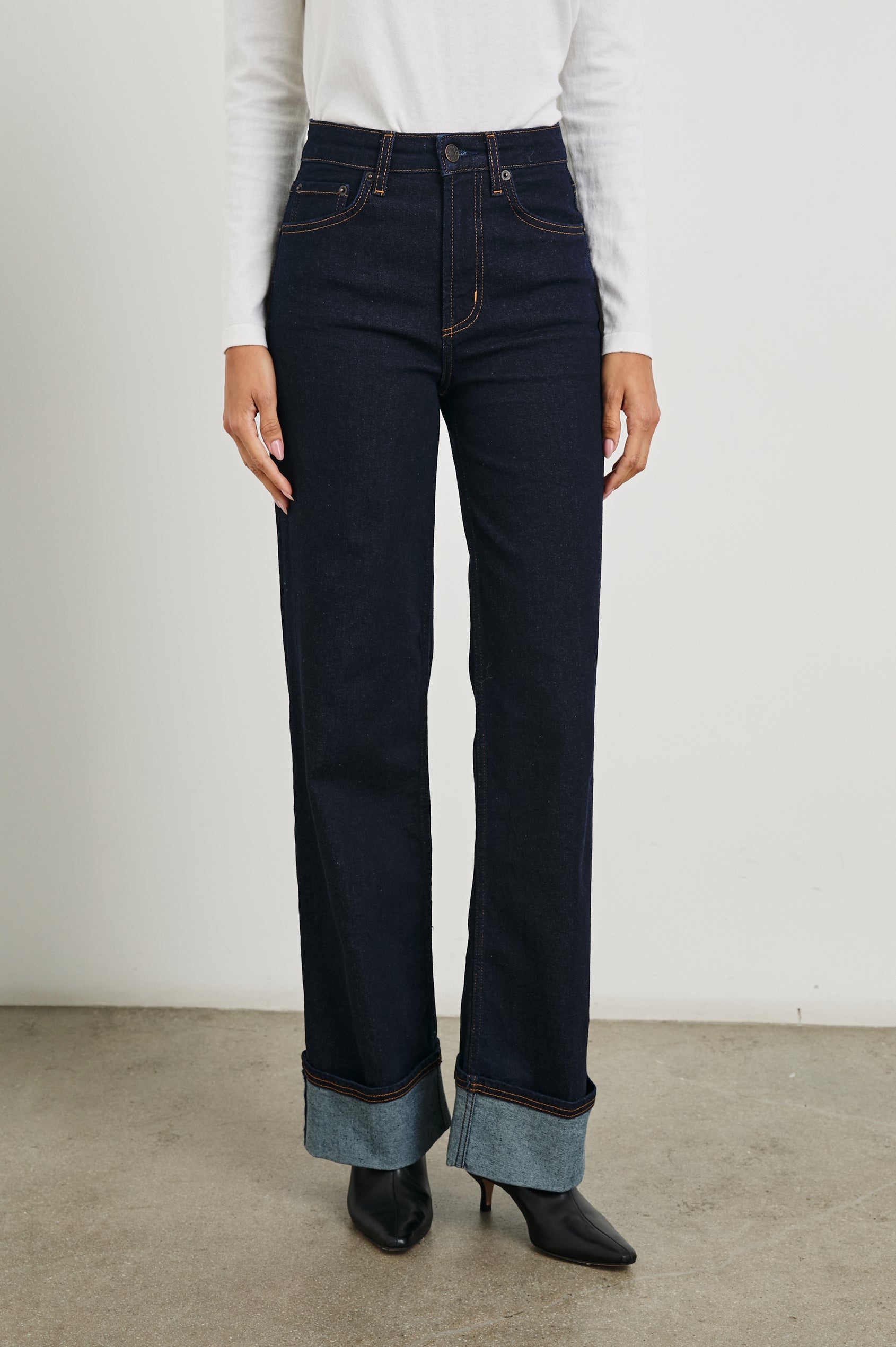 Getty Wide Leg Denim Pants with Cuffed Hems, Belt Loops, Two Front Pockets and Two Back Patch Pockets in Midnight Blues Cuffed Colorway - Front View Featured on Model