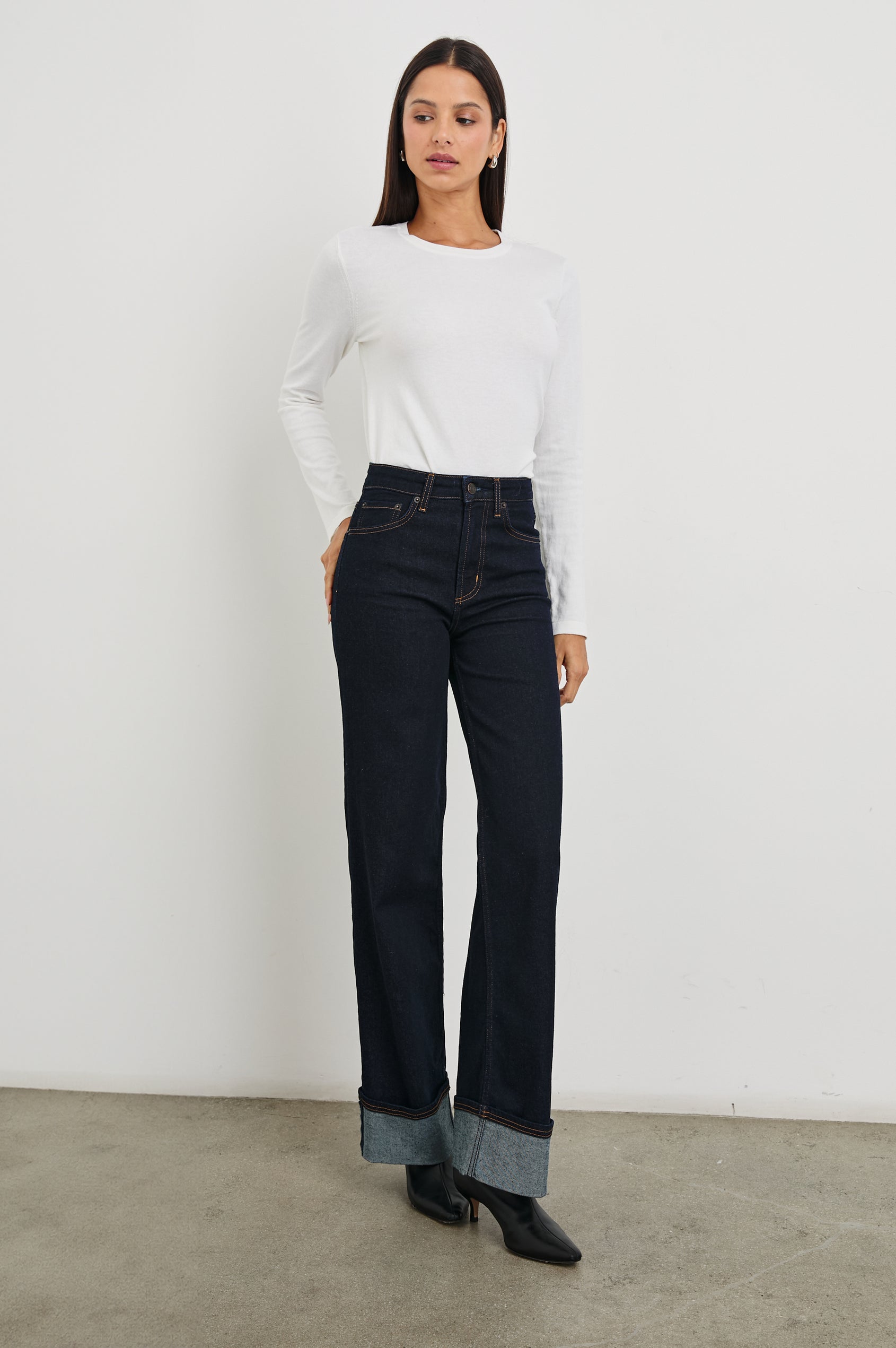 Getty Wide Leg Denim Pants with Cuffed Hems, Belt Loops, Two Front Pockets and Two Back Patch Pockets in Midnight Blues Cuffed Colorway - Front Full Body View Featured on Model