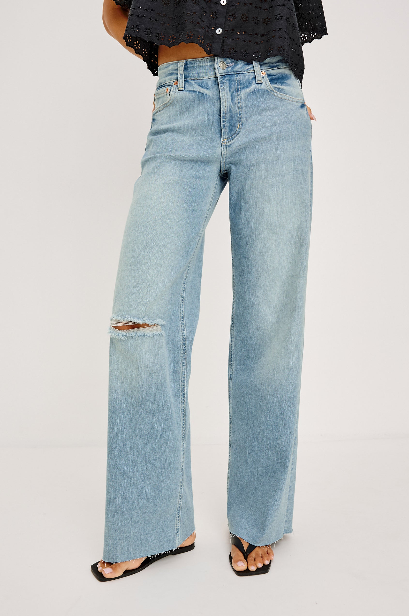 Getty Wide Leg Jean in Light Stretch Denim With Mid-Rise, 5-Pockets, Distressed Detailing, and Raw Hem in Waverider Colorway - Lower Body Front View Featured on Model