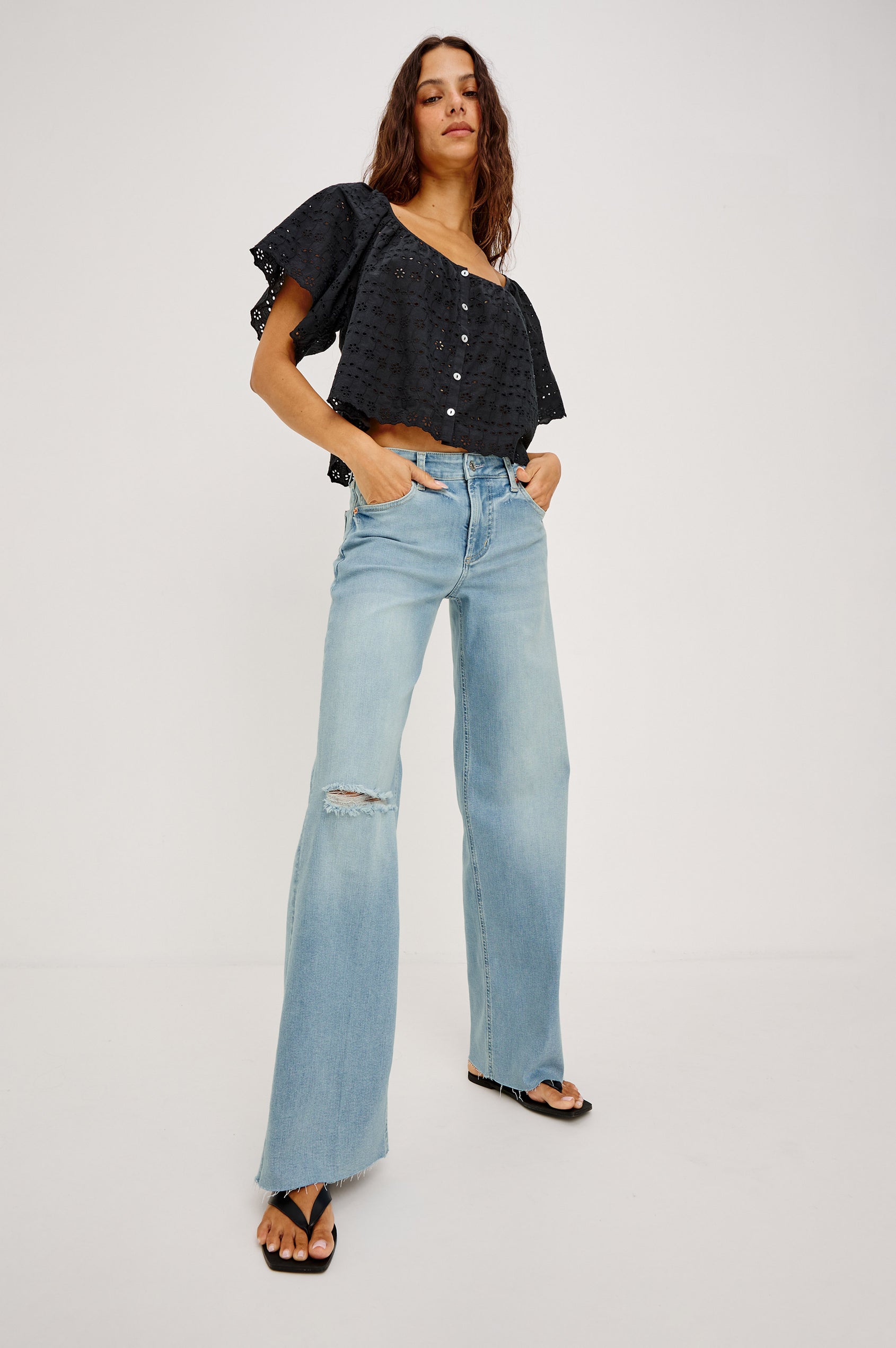 Getty Wide Leg Jean in Light Stretch Denim With Mid-Rise, 5-Pockets, Distressed Detailing, and Raw Hem in Waverider Colorway - Lower Body Front View Featured on Model