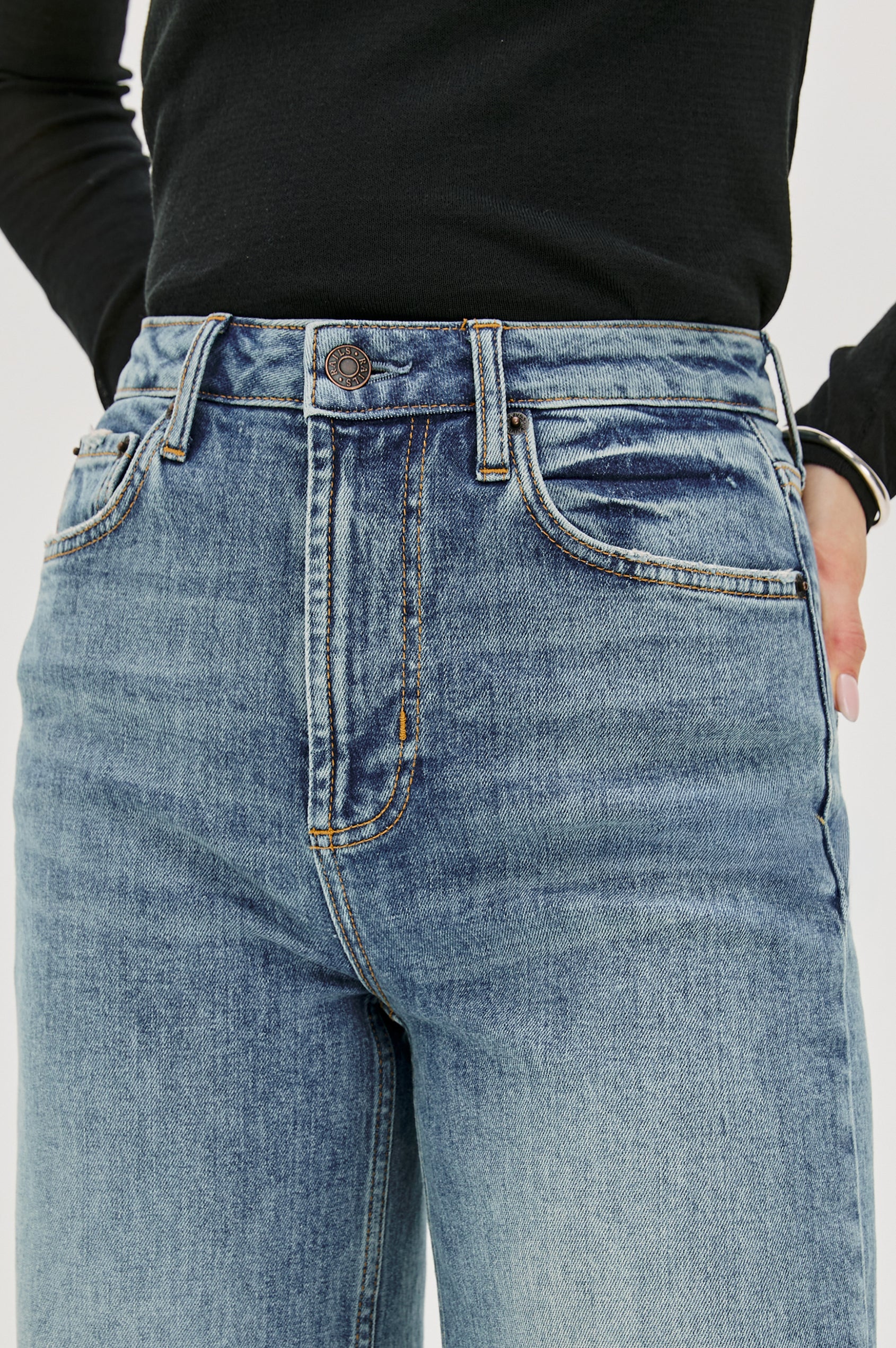 Getty full length 5-pocket wide leg jean in Tradewind colorway, a medium wash. Front detail view featured on model.