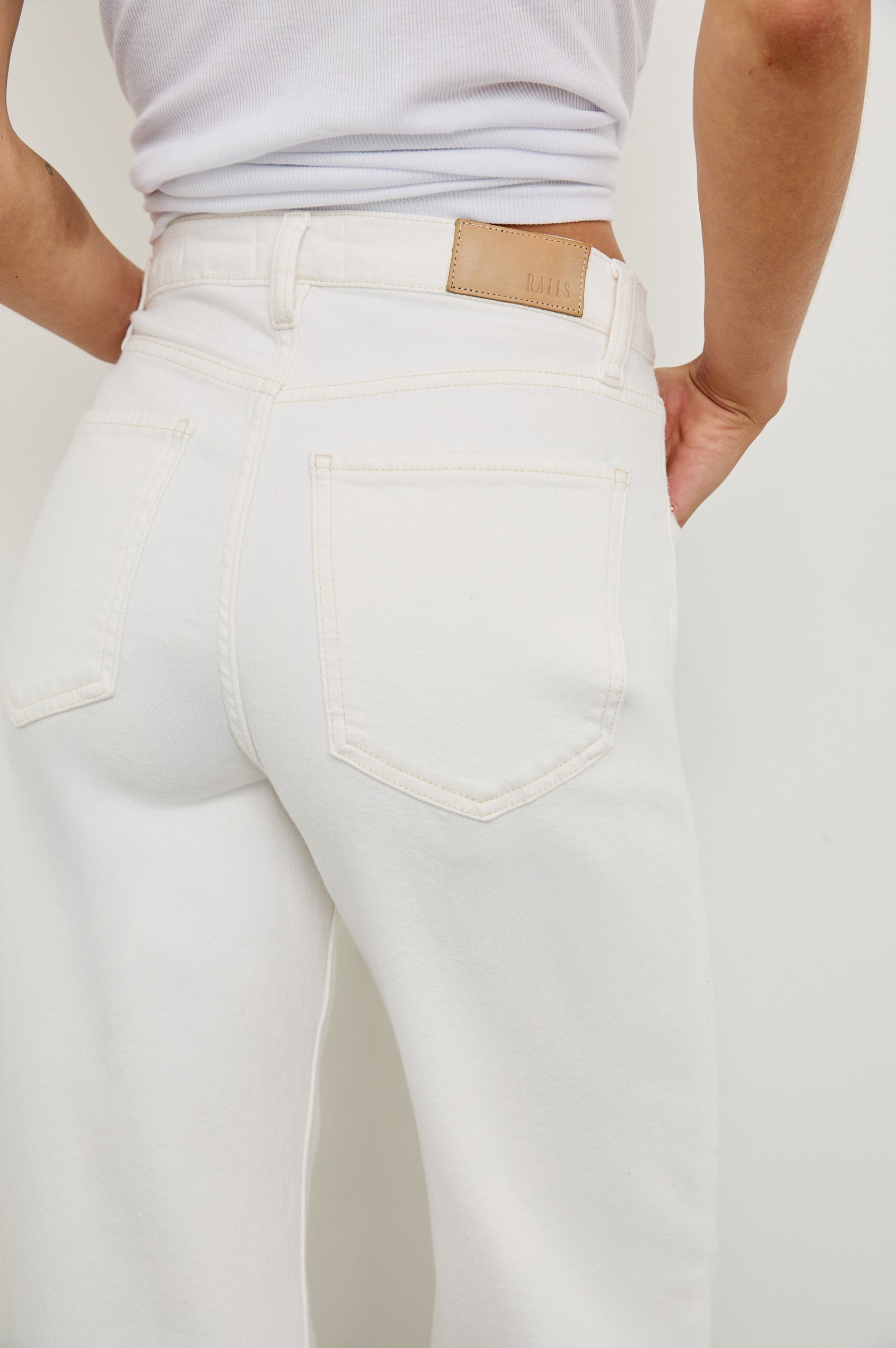 Getty high rise flared jean with long inseam and cuffed bottom details in Ecru Cuffed - close up of back details on model