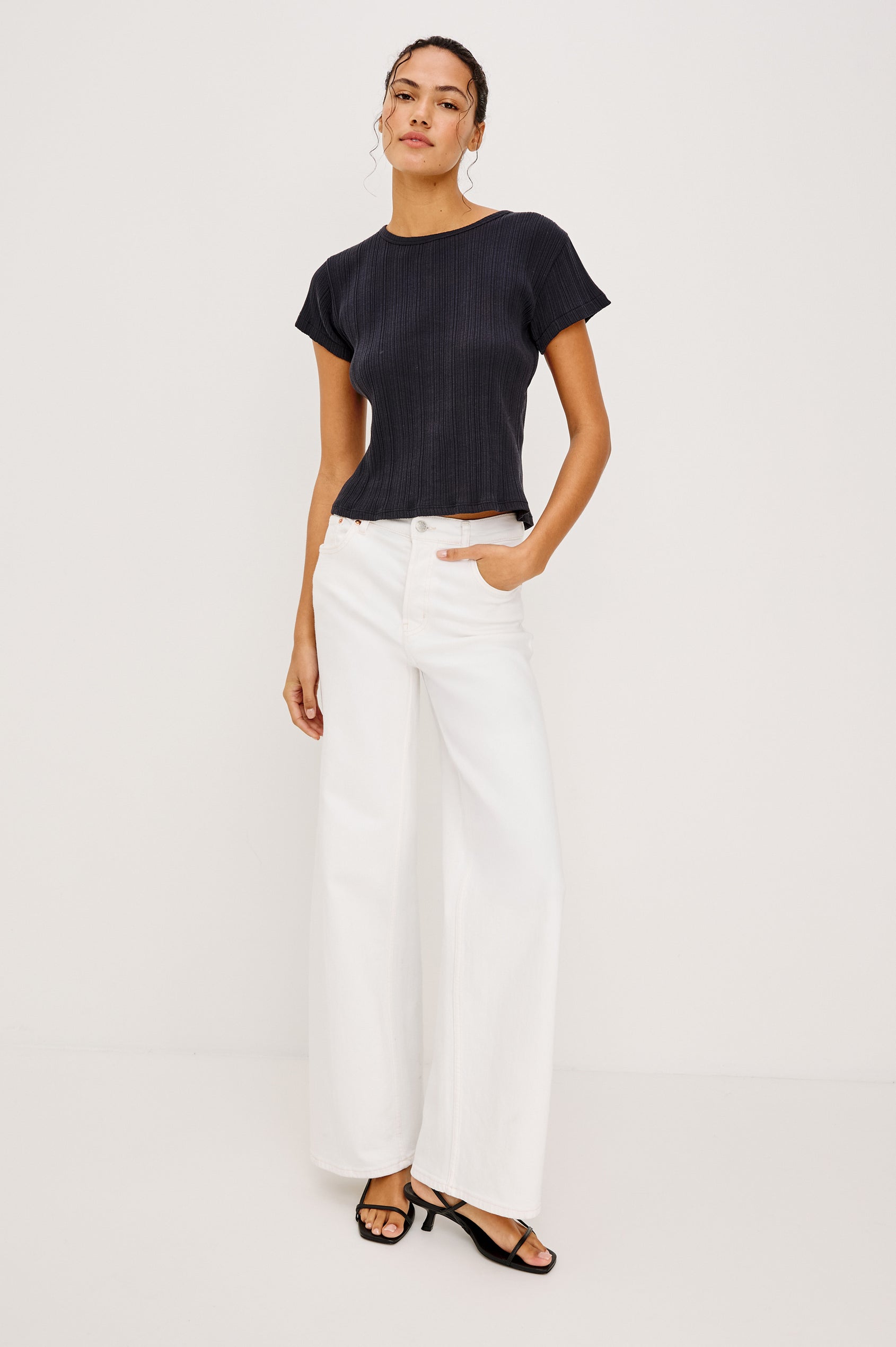 Getty Wide Leg Jean in Light Stretch Denim With High-Rise High-Waisted Fit, Button Fly, and 5-Pocket Styling in Vintage Ecru Colorway - Full Body Front View Featured on Model