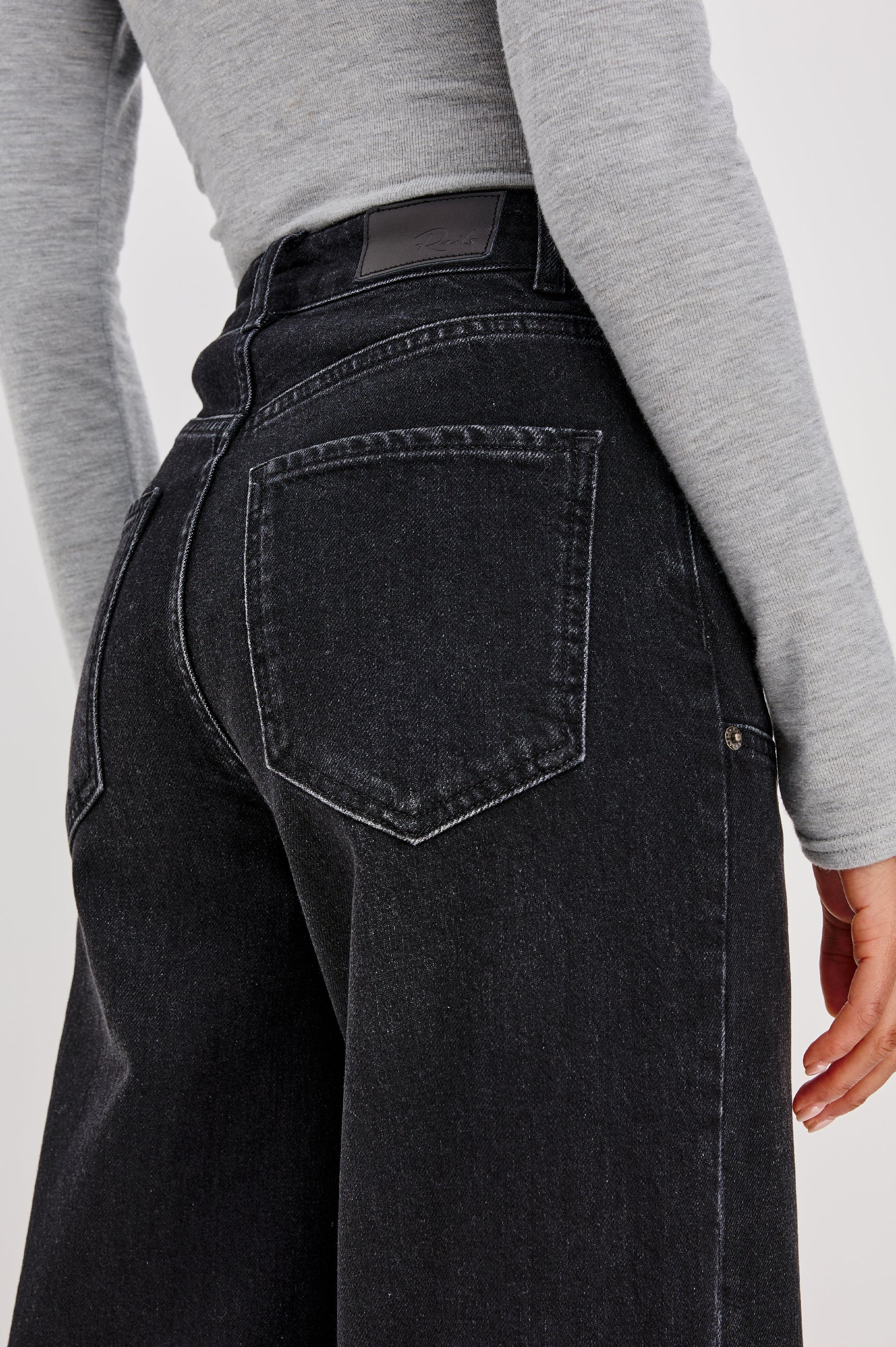 Getty Wide Leg Jean in Denim With High-Rise High-Waisted Fit, Front Button Fly, Carpenter Leg Panels, and 5-Pocket Styling in Onyx Colorway - Lower Body Back Close Up View Featured on Model