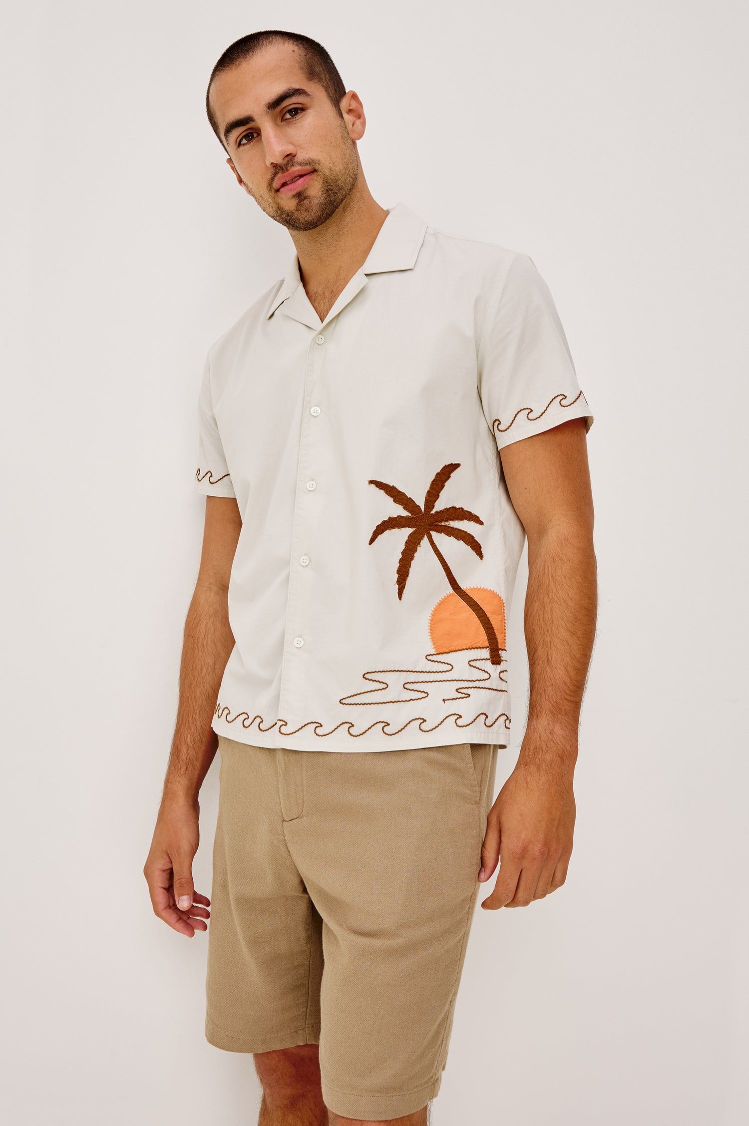 Gibson Button-Up Shirt in Stretch Linen Blend With Short Sleeves, Notched Collar, and Palm Tree Embroidery in Natural Sunset Colorway - Upper Body Front View Featured on Model