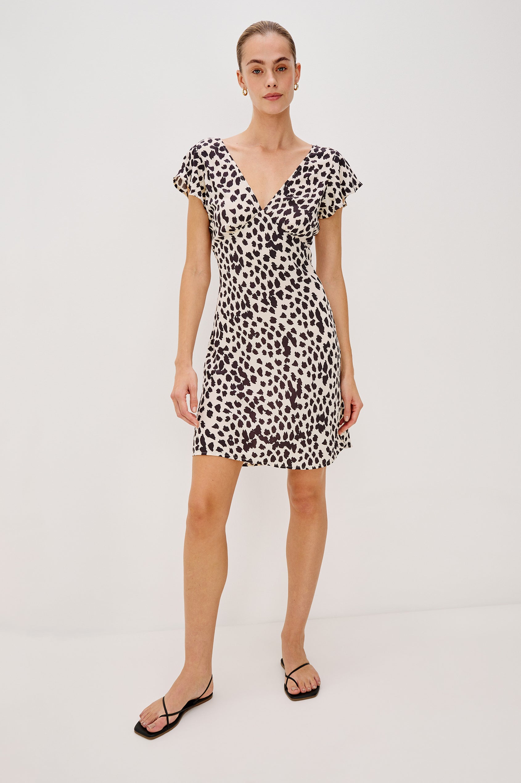 Gigi V-Neck Mini Dress with Short Flutter Sleeves, Empire Waist  in Taupe Spotted Colorway. Full Body Front View Shown on Model.