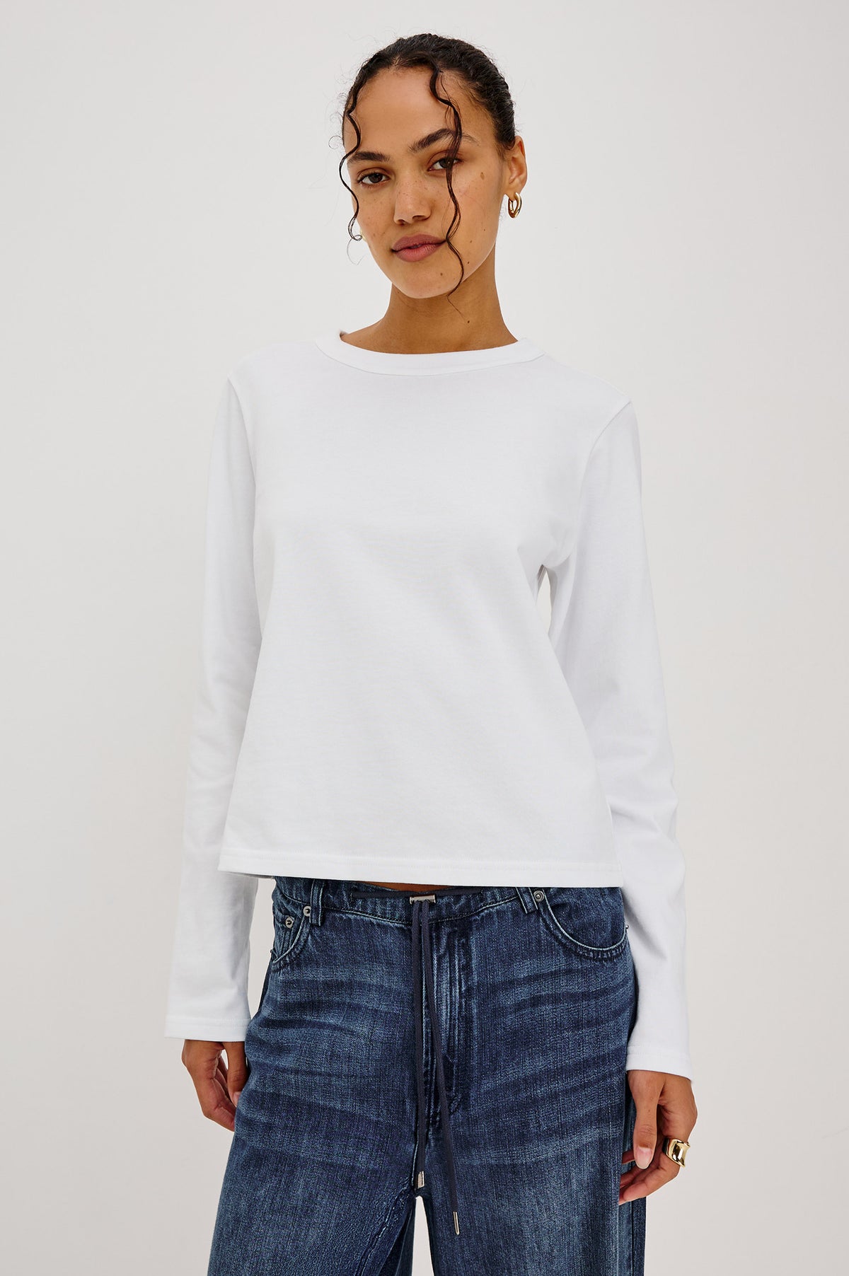 Long Sleeve Girlfriend Tee in Midweight Pleated Jersey in Slightly Boxy Cropped Fit With Crew Neckline in White Colorway - Upper Body Front View Featured on Model.